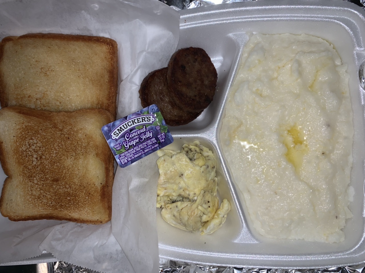 Order 2 Buttered Toast, Grits, 2 Eggs and 2 Sausage food online from Meraki Kitchen store, Houston on bringmethat.com