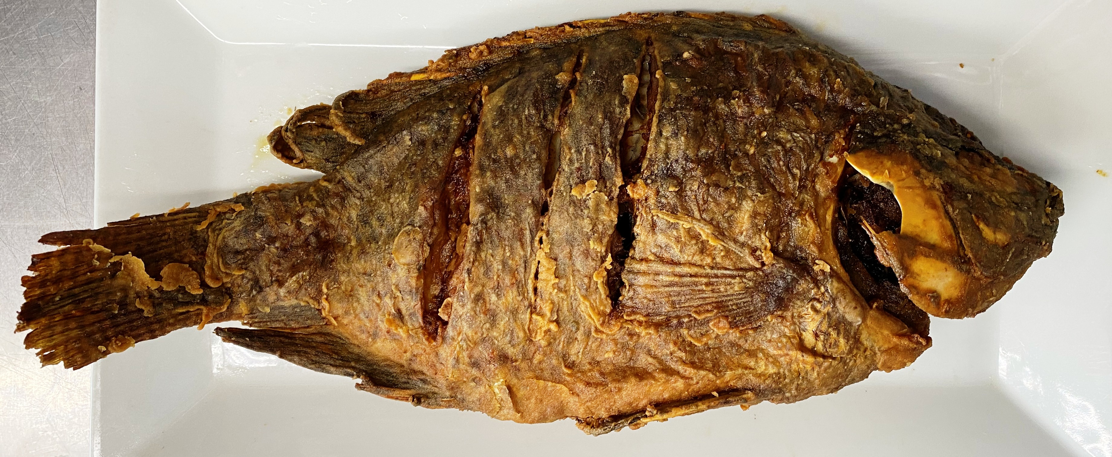 Order Whole Fried Tilapia food online from Los Latinos Deli store, Long Beach on bringmethat.com