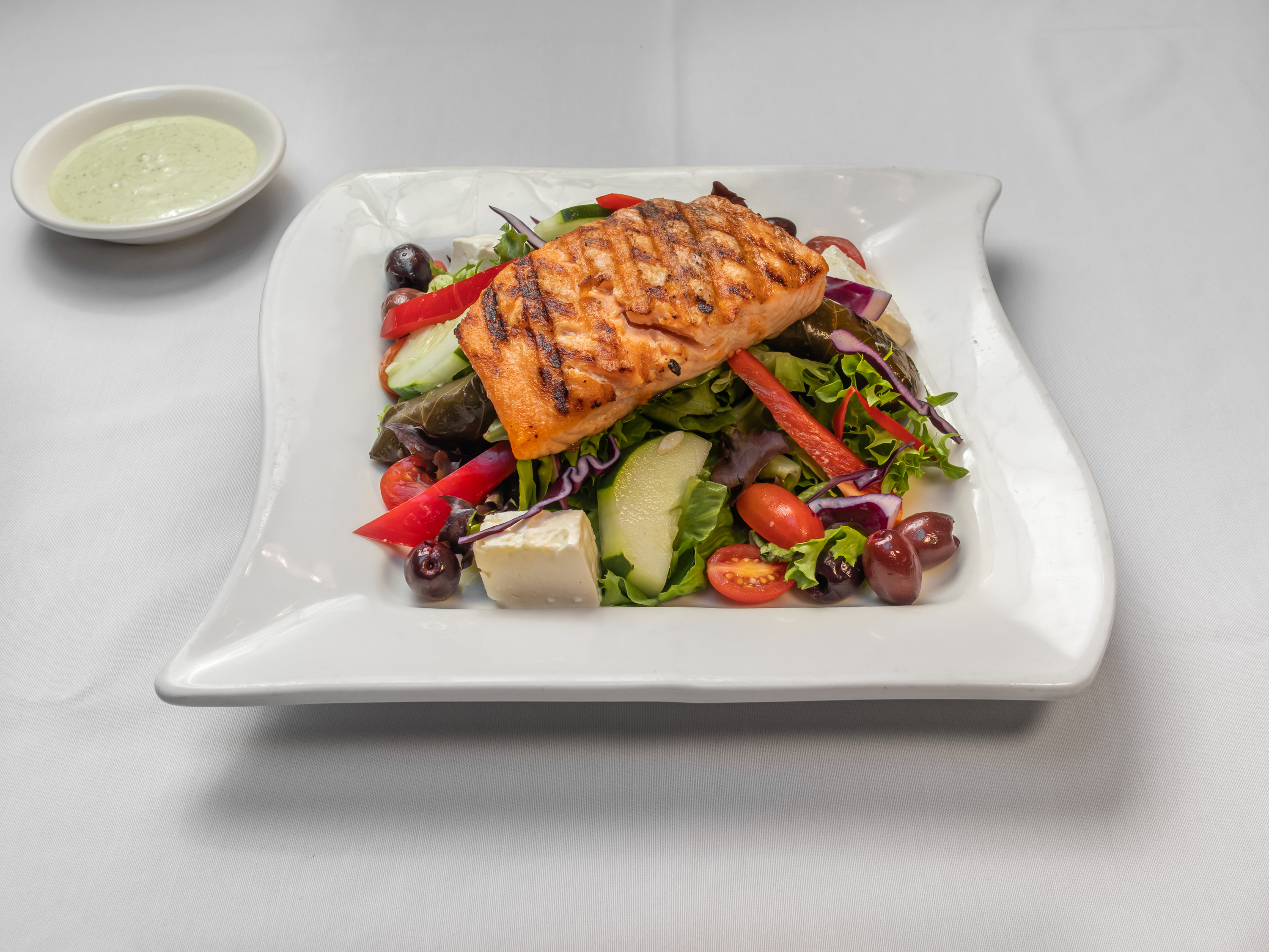 Order Grilled wild Salmon over Greek Salad  food online from Mazzat store, Brooklyn on bringmethat.com