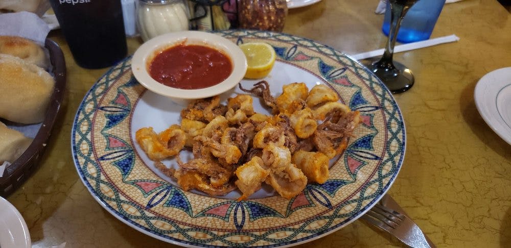 Order Fried Calamari with Sauce - Appetizer food online from Napolis Italian Restaurant store, Terrell on bringmethat.com