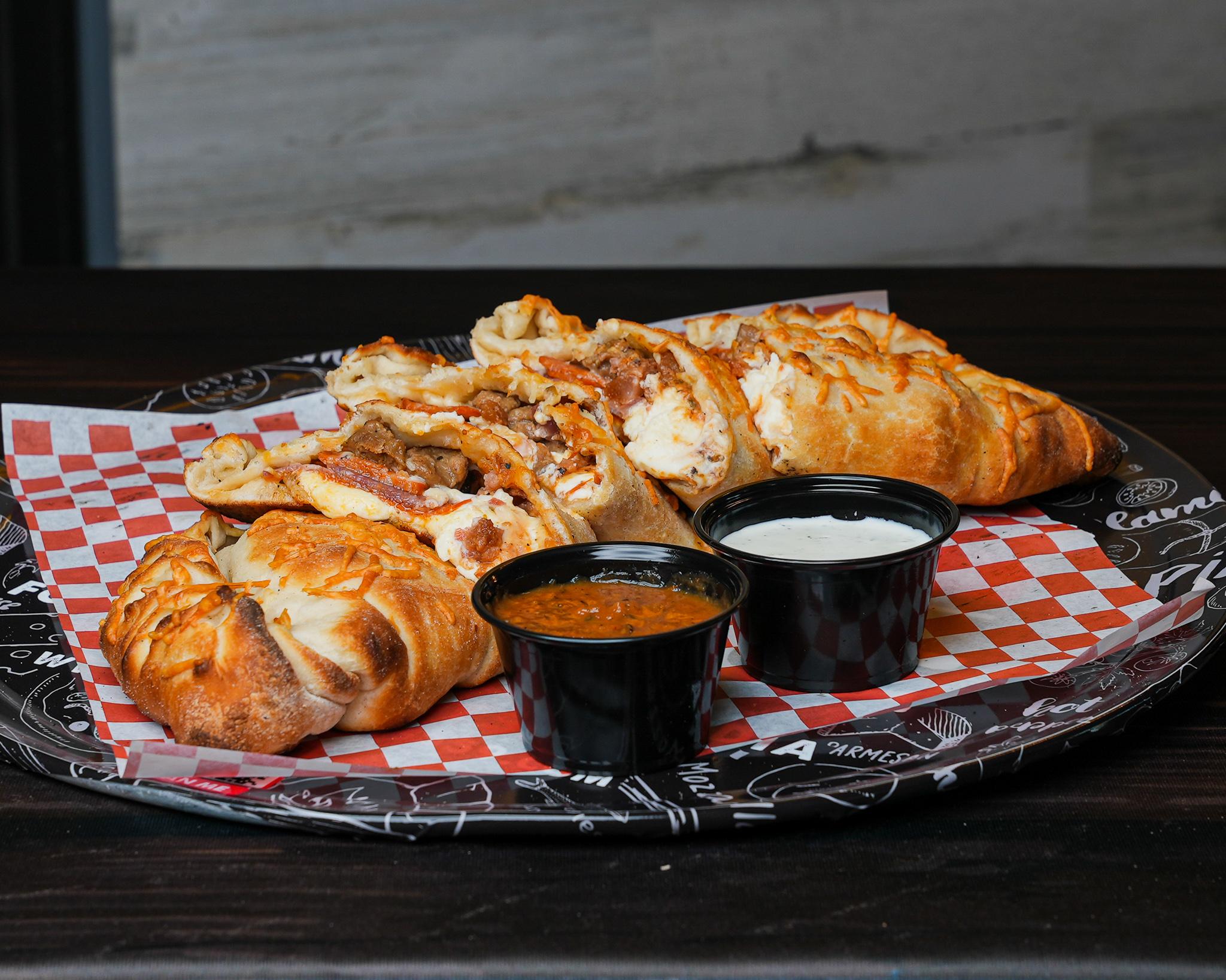 Order The MeatyZone Calzone food online from Dough Boys Pizzeria store, Clovis on bringmethat.com