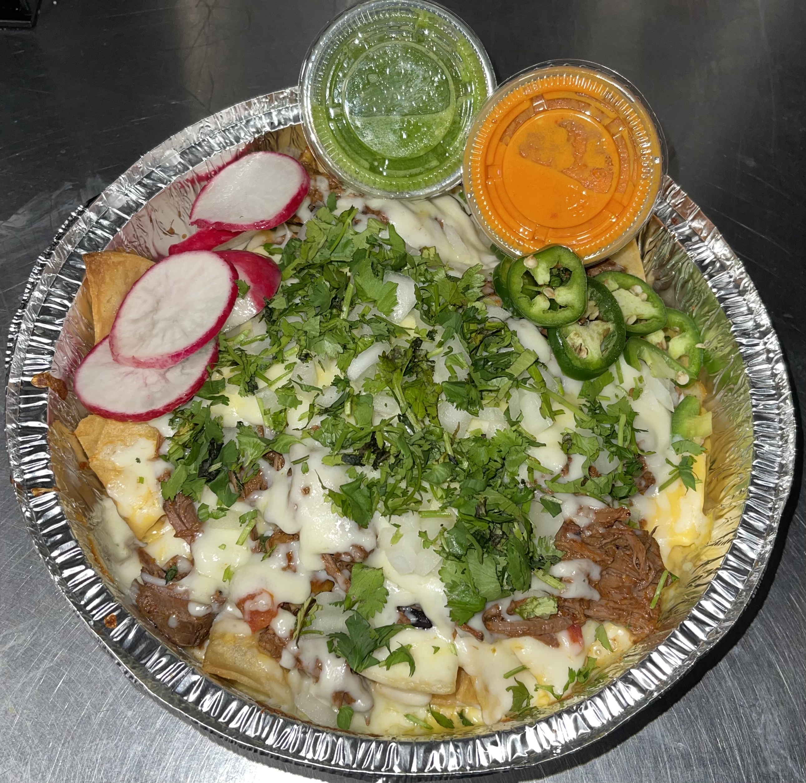 Order Birria nachos W/Consome food online from La Catrachita Food Truck store, Philadelphia on bringmethat.com