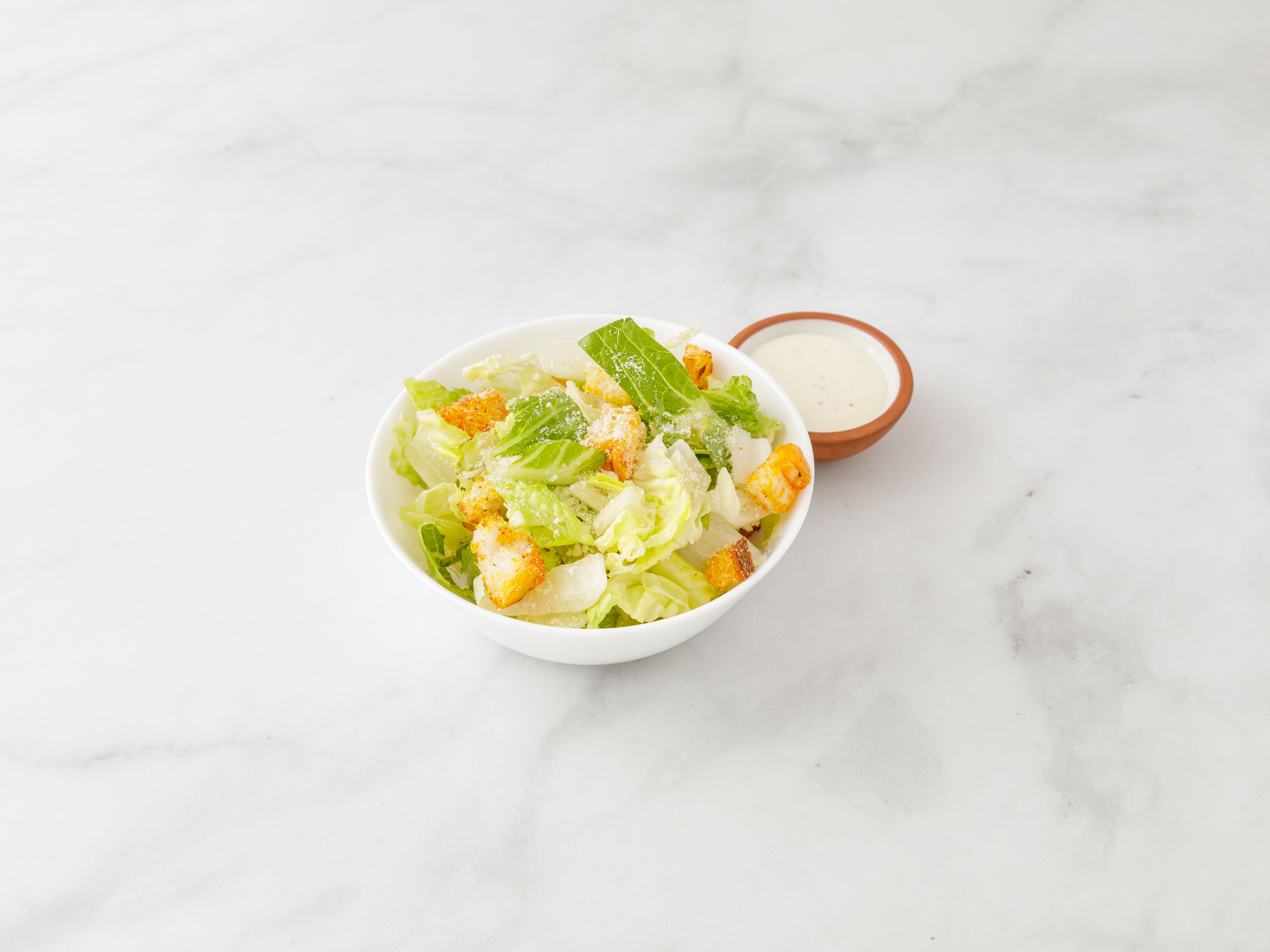 Order Caesar Salad food online from Cugini Pizzeria & Restaurant store, Mineola on bringmethat.com