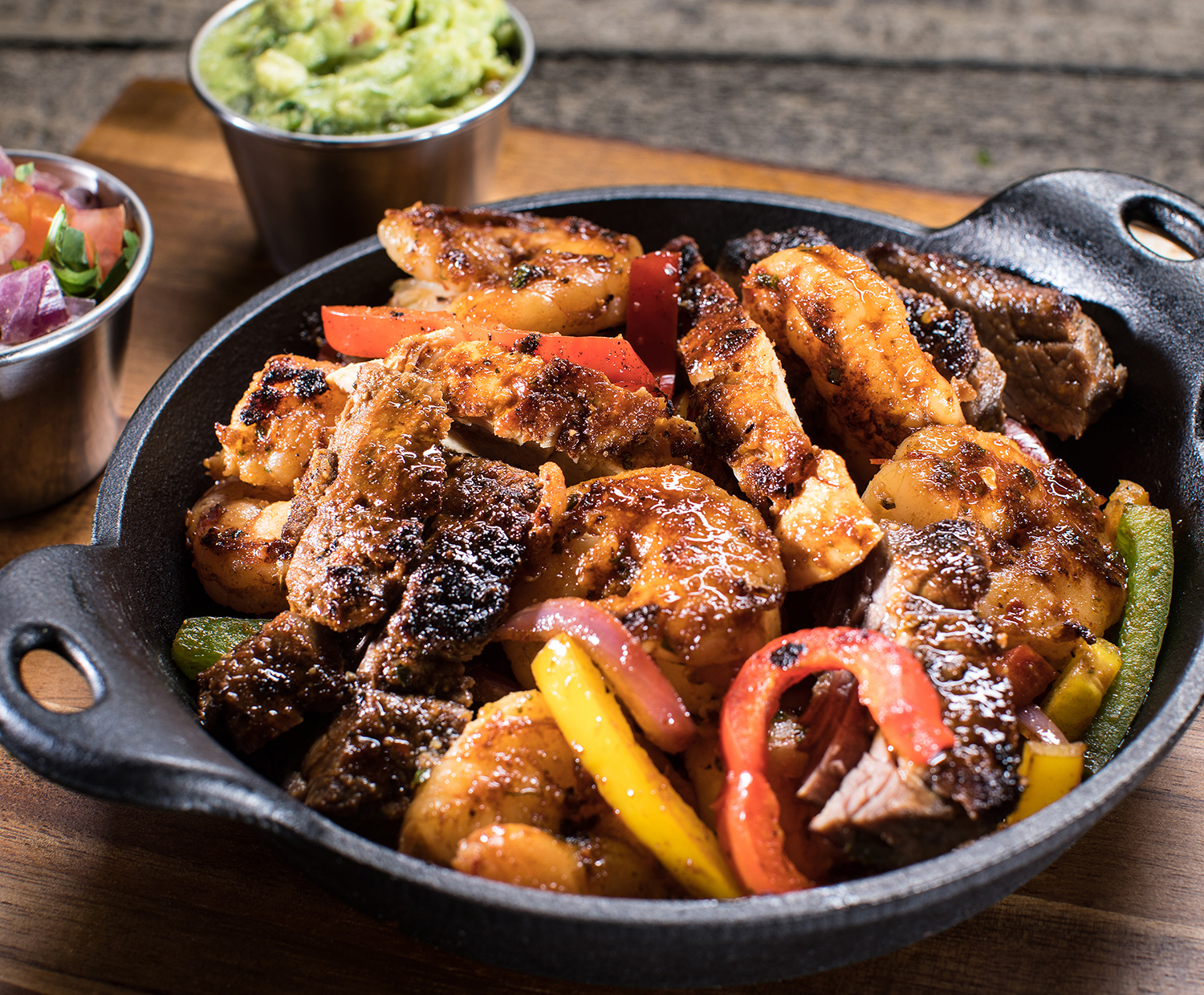 Order Chicken, Carne Asada Steak and Shrimp Fajitas food online from Mixteco Mexican Grill store, Chicago on bringmethat.com