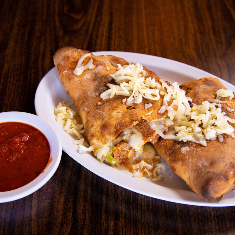 Order Smothered Sausage Calzone food online from Rico Pizzeria store, Englewood on bringmethat.com
