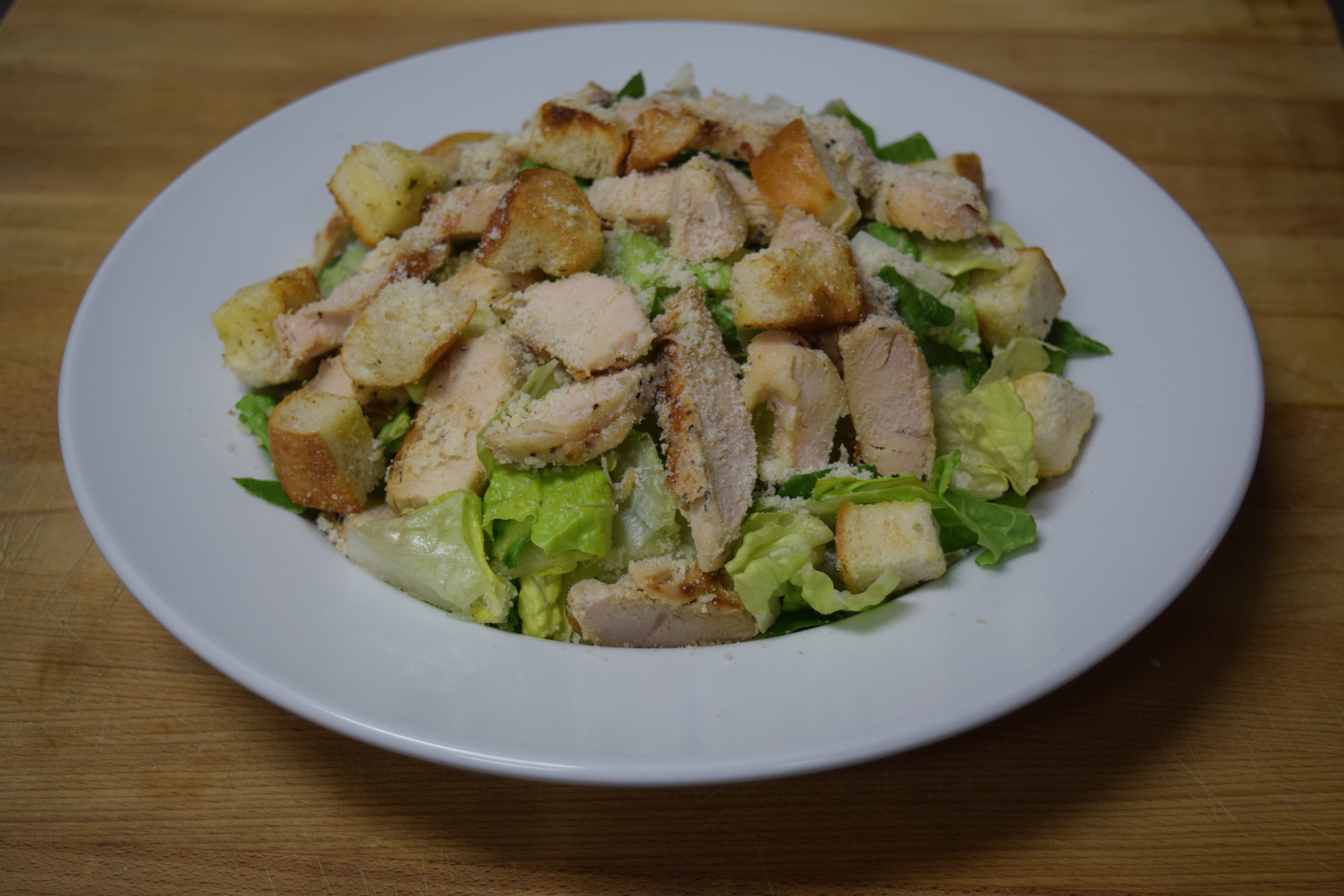 Order Chicken Caesar Salad food online from Cuzino's store, Bear on bringmethat.com