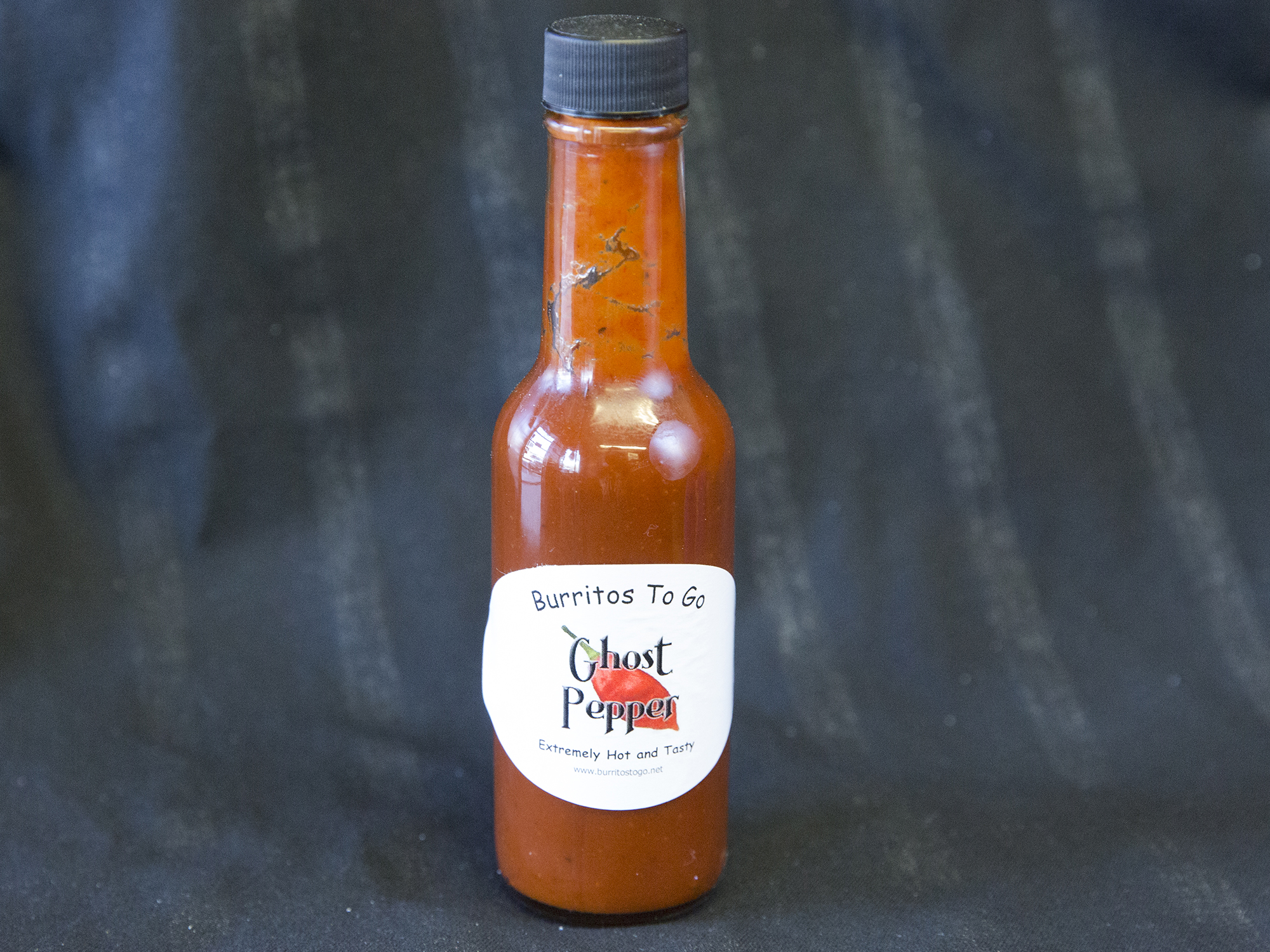 Order Bottle of Ghost Chili Sauce XX Hot food online from Burritos To Go store, Broomfield on bringmethat.com