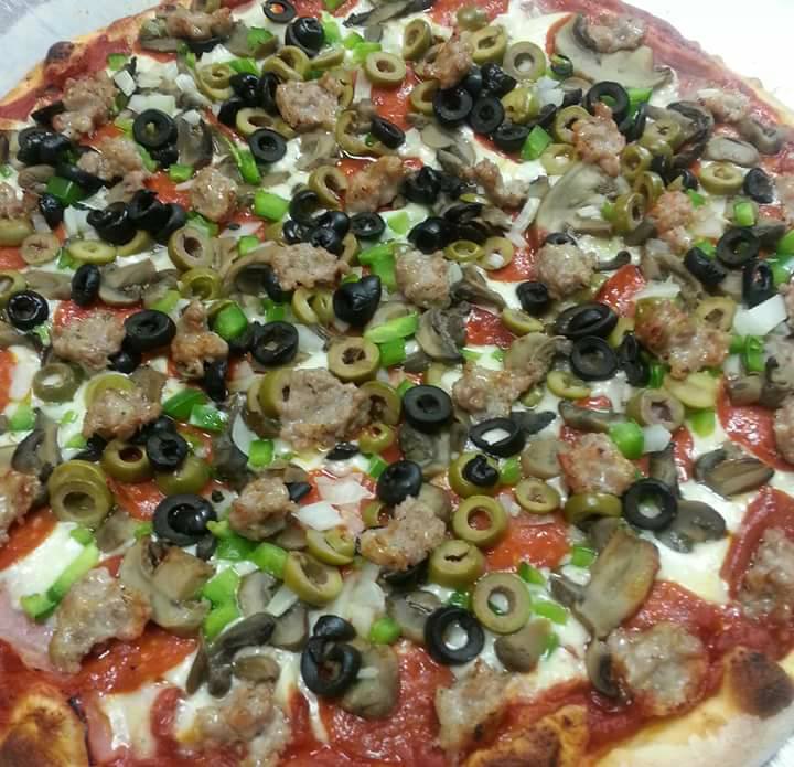 Order Deluxe Pizza food online from Carmelos Italian Pizza store, Caledonia on bringmethat.com