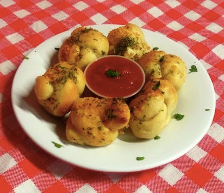 Order Garlic Knots with Tomato Sauce - Appetizer food online from IL Villaggio store, Suffern on bringmethat.com