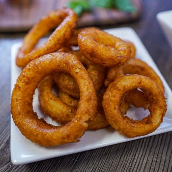 Order Thick Cut Onion Rings - Side food online from Foxs Pizza Den store, Belle Vernon on bringmethat.com
