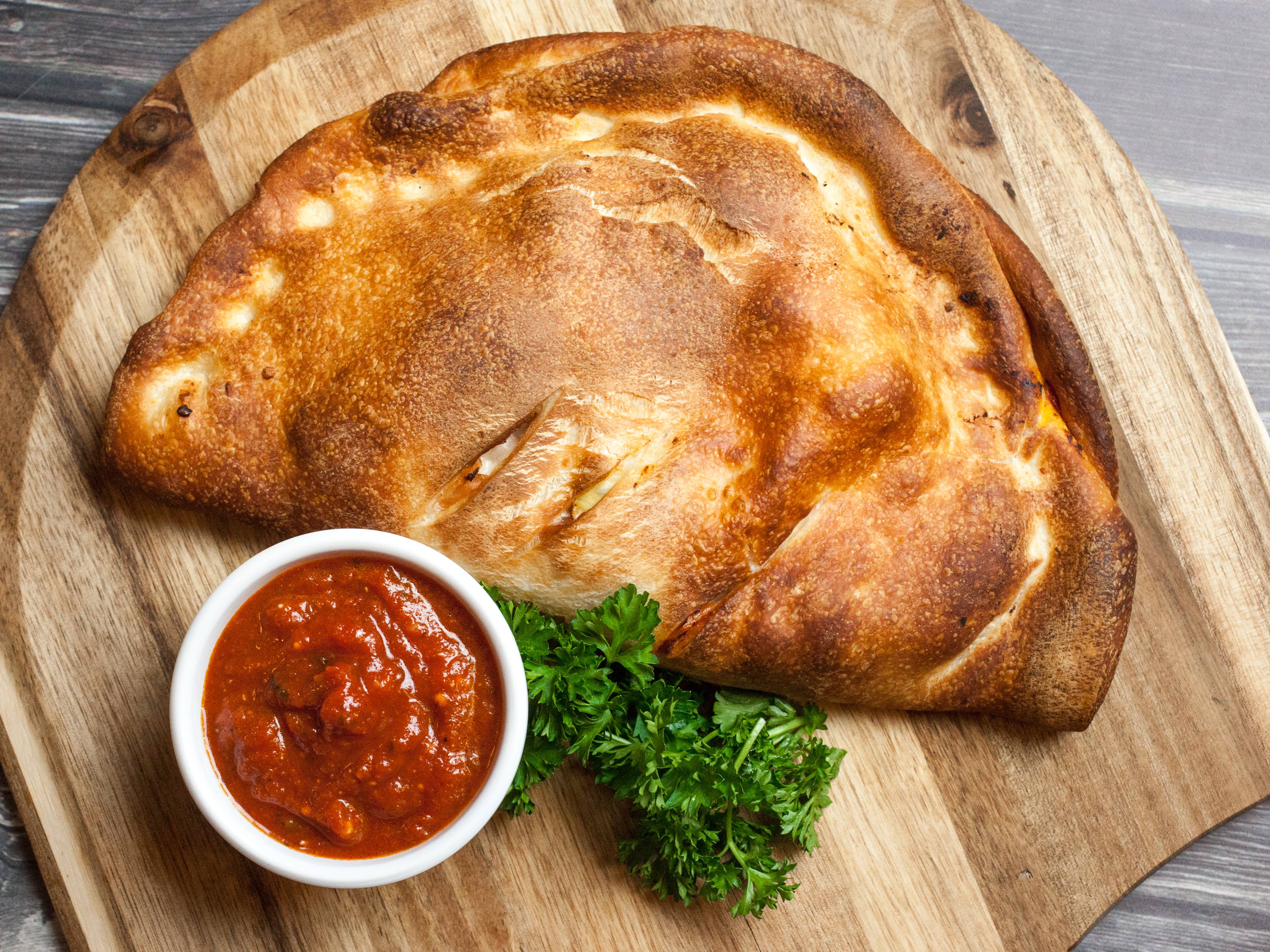 Order Veggie Calzone food online from Milano Pizza and Pasta store, Seattle on bringmethat.com