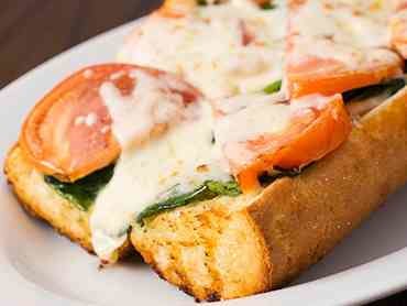 Order Garlic Bread with Spinach & Tomato - Appetizer food online from Rosati Pizza store, North Pekin on bringmethat.com