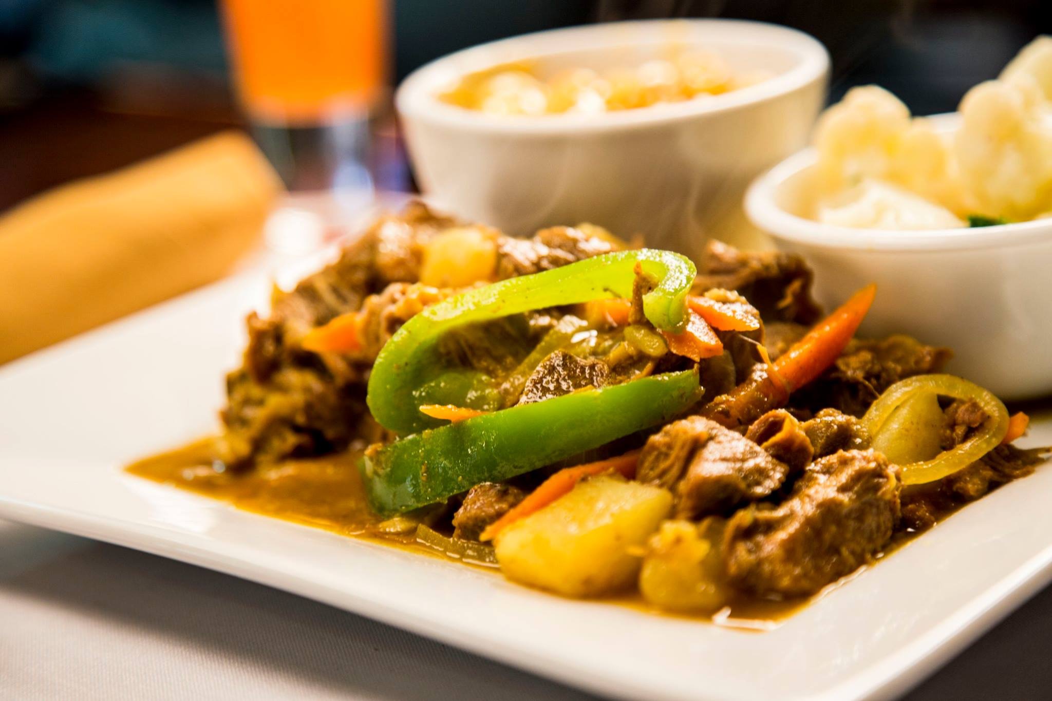 Order Family Curry Goat food online from Spice Island Grill store, Colorado Springs on bringmethat.com