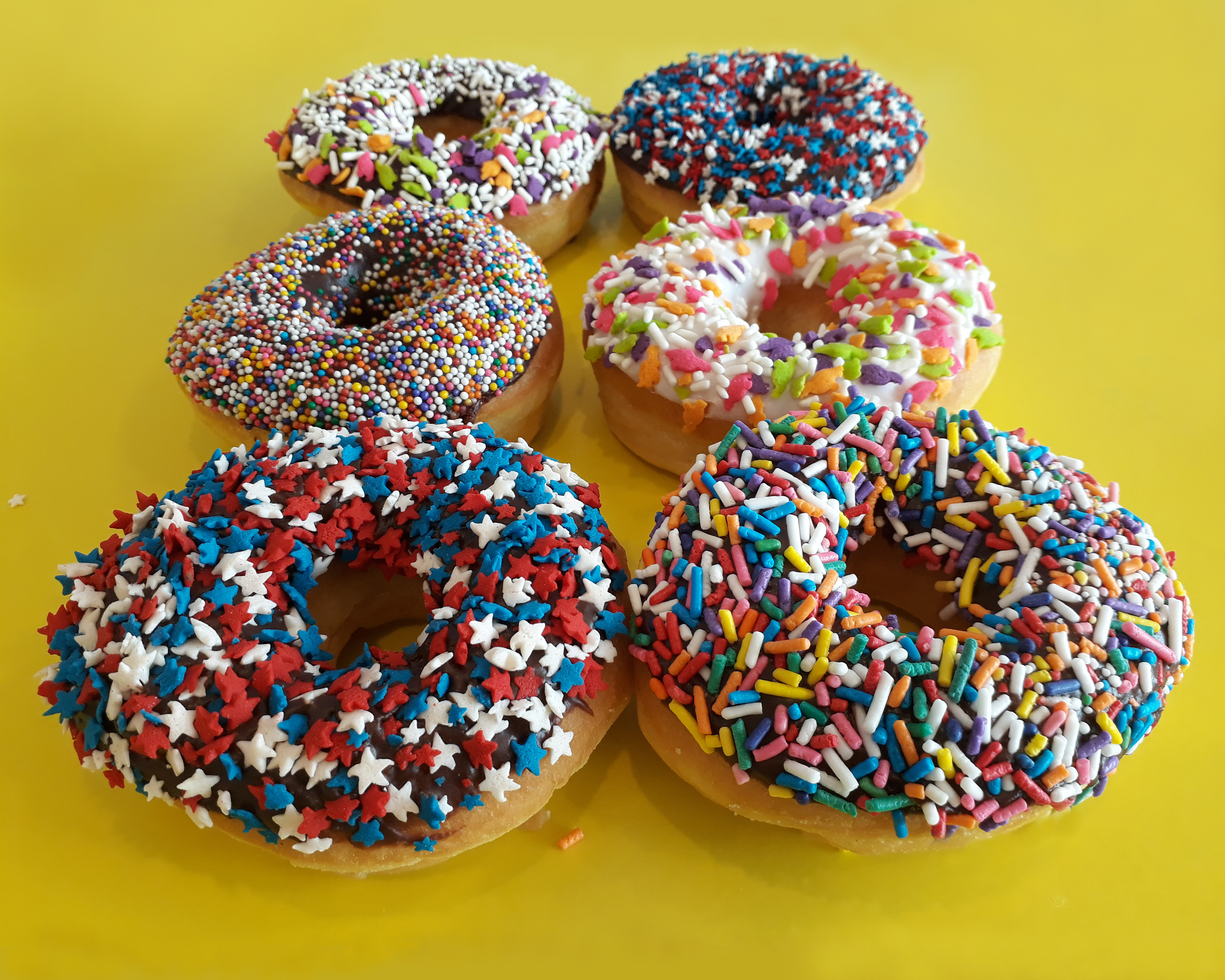 Order 1 Dozen All Sprinkled Donut food online from Jaram's Donuts store, Dallas on bringmethat.com