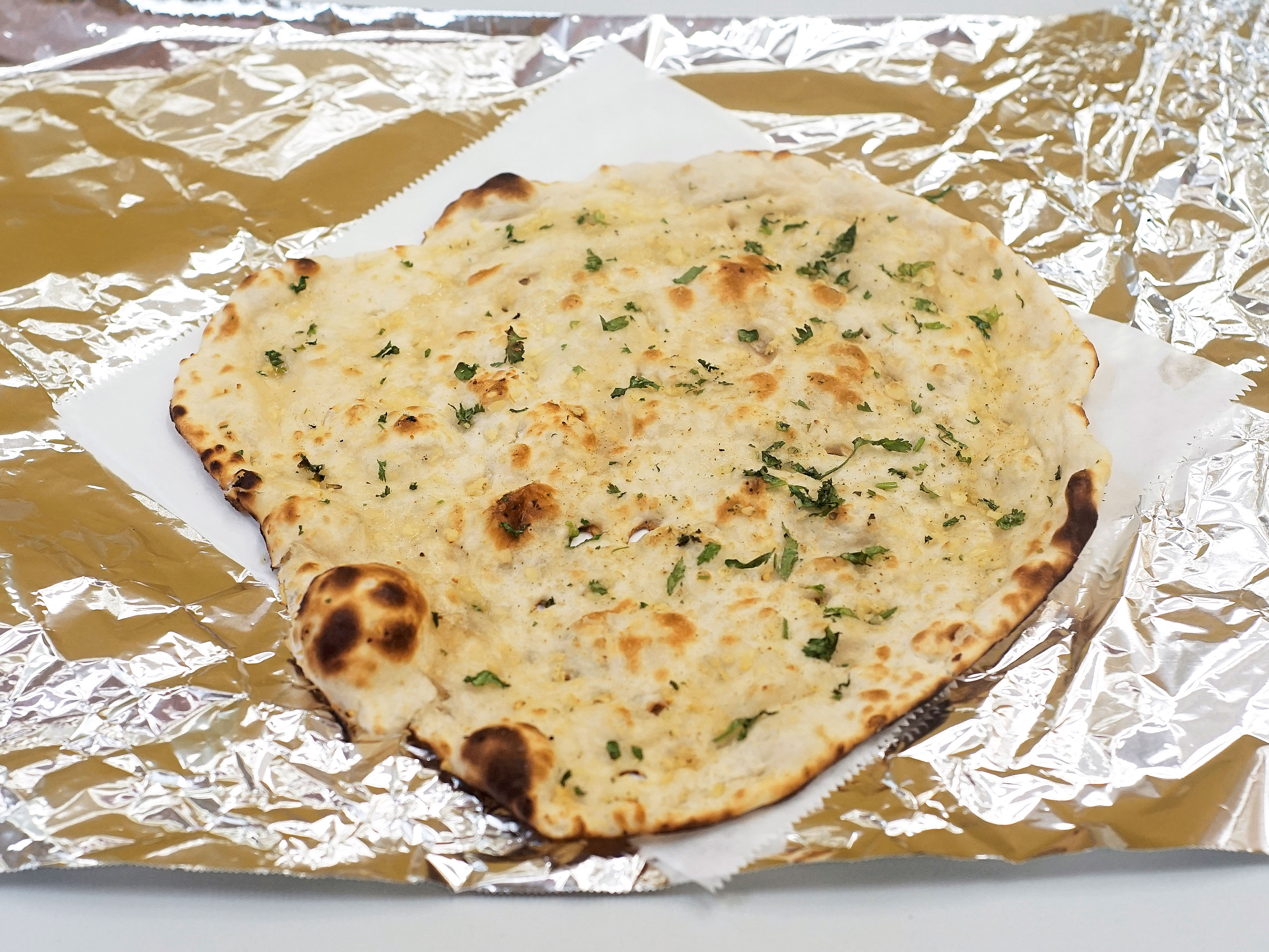 Order Garlic Naan food online from Dhaba Indian Kitchen store, Northville on bringmethat.com