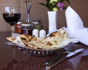 Order Garlic Naan food online from Punjab Palace store, Boston on bringmethat.com