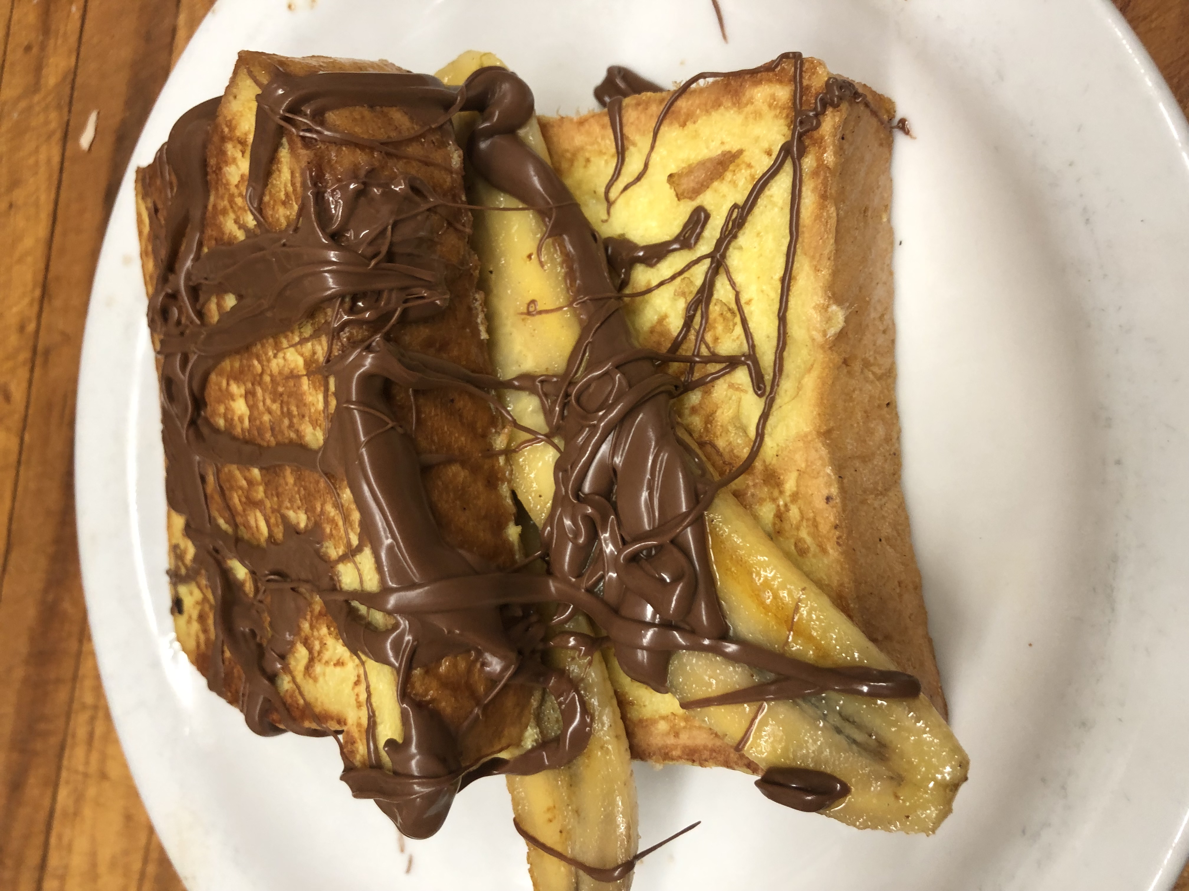 Order Banana Nutella French Toast, with 2 eggs food online from Al Cafe In The Village store, Carlsbad on bringmethat.com