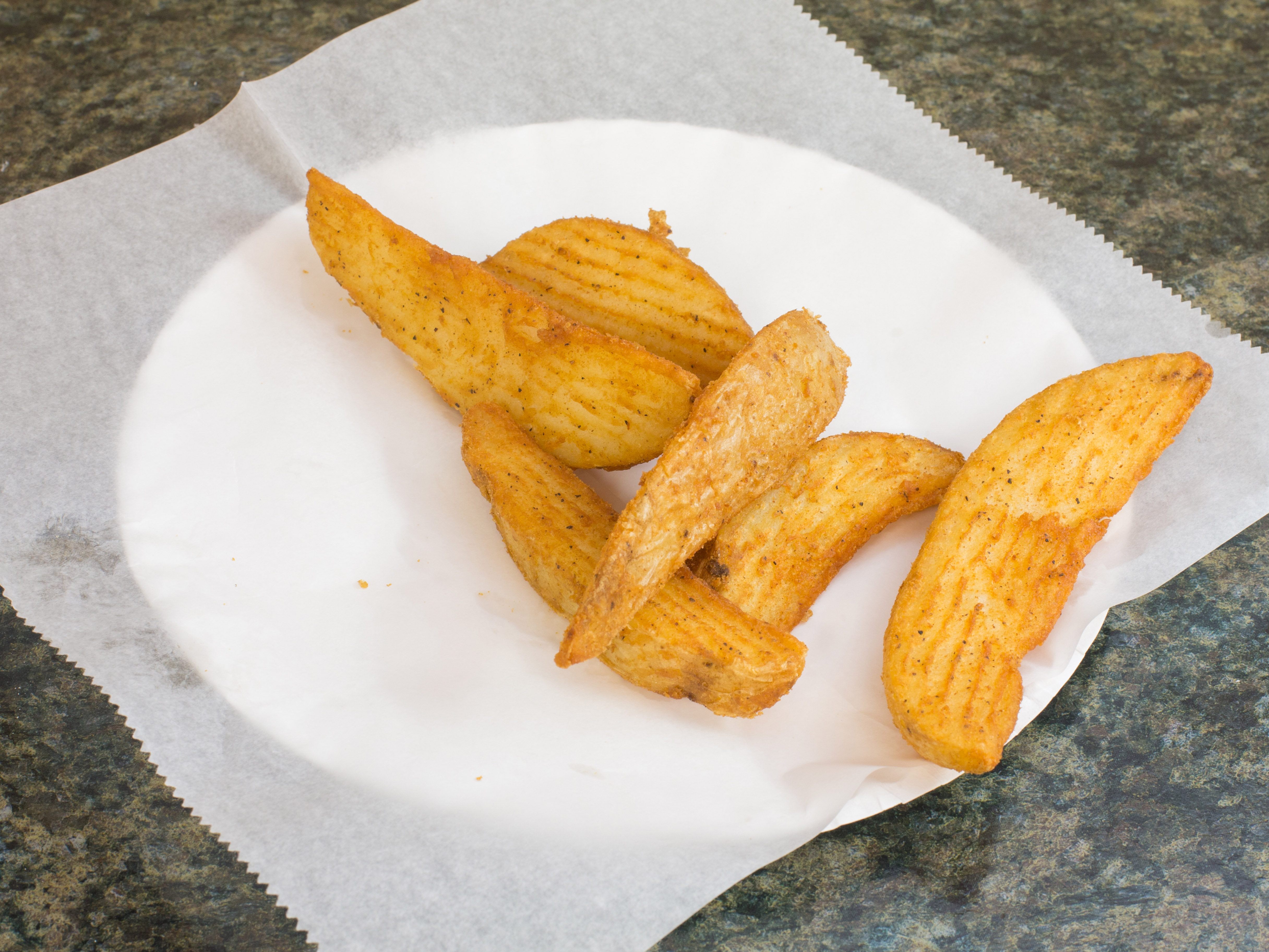 Order 12 Pieces Potato Wedges food online from Kennedy Pizza & Fried Chicken store, Newark on bringmethat.com