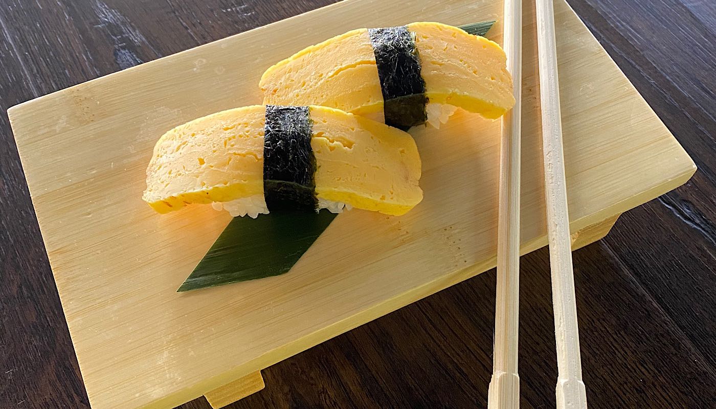 Order Tamago Nigiri - 2 Pieces food online from Sushi Train store, Minneapolis on bringmethat.com