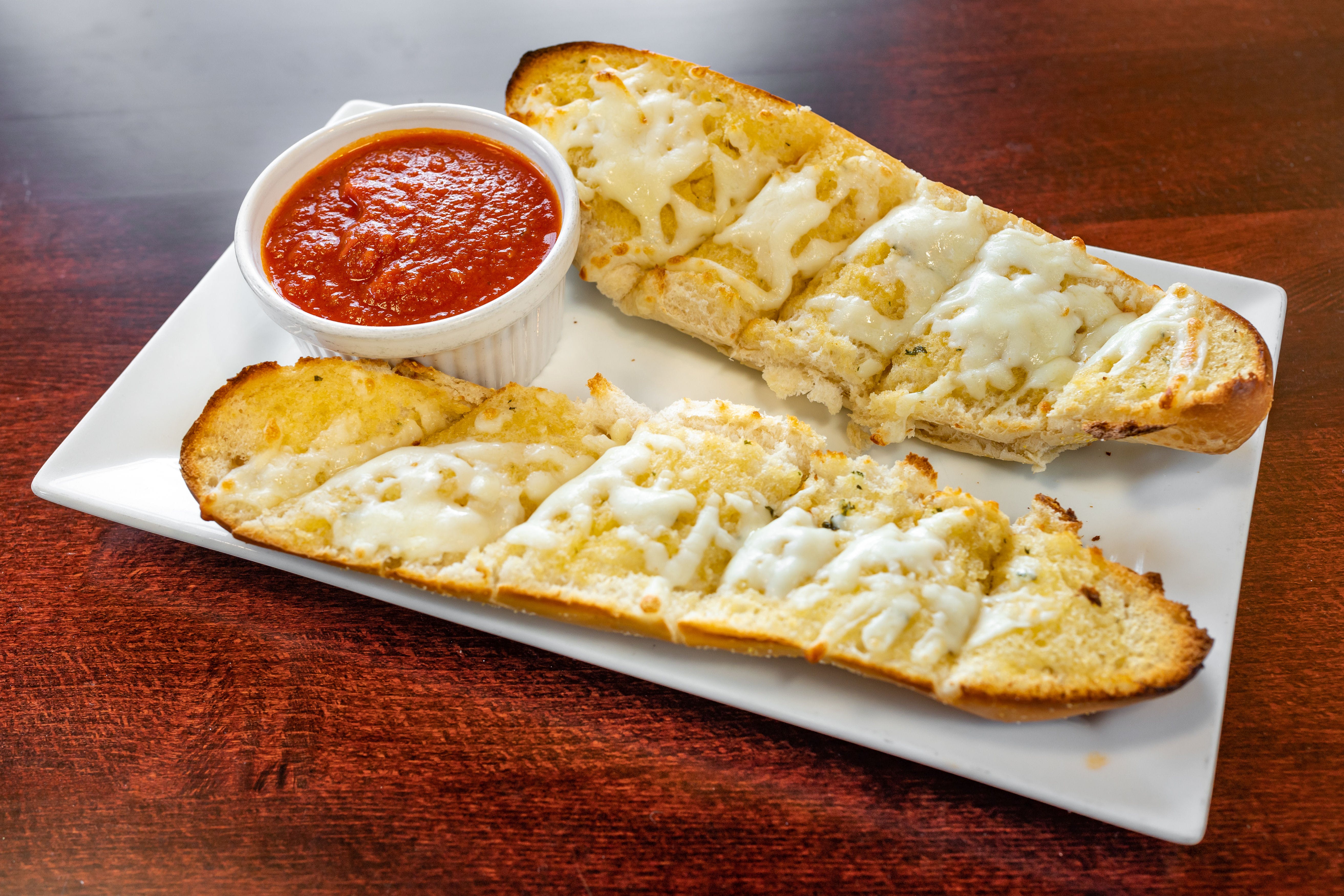 Order Garlic Bread with Cheese - Appetizers food online from Capriccios Italian Restaurant store, Henrico on bringmethat.com