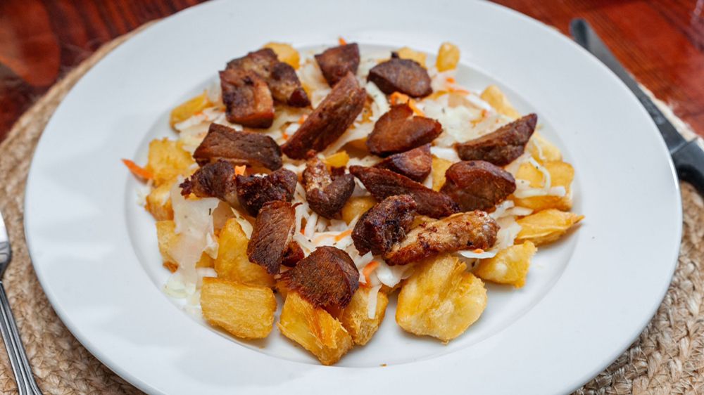 Order Fried Yuca with Fried Pork Bits food online from La Cabana Salvadorena store, New York on bringmethat.com