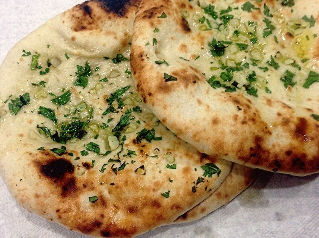 Order Garlic Naan food online from Swad Indian and Nepalese Cousine store, Fort Worth on bringmethat.com