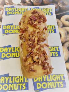 Order Maple Bacon Long John  food online from Daylight Donuts Op store, Overland Park on bringmethat.com