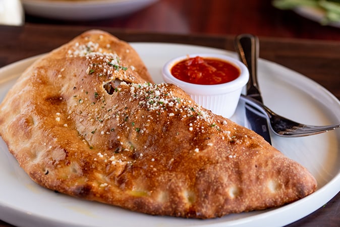 Order New York Calzone food online from Rocco's Pizzeria store, San Antonio on bringmethat.com