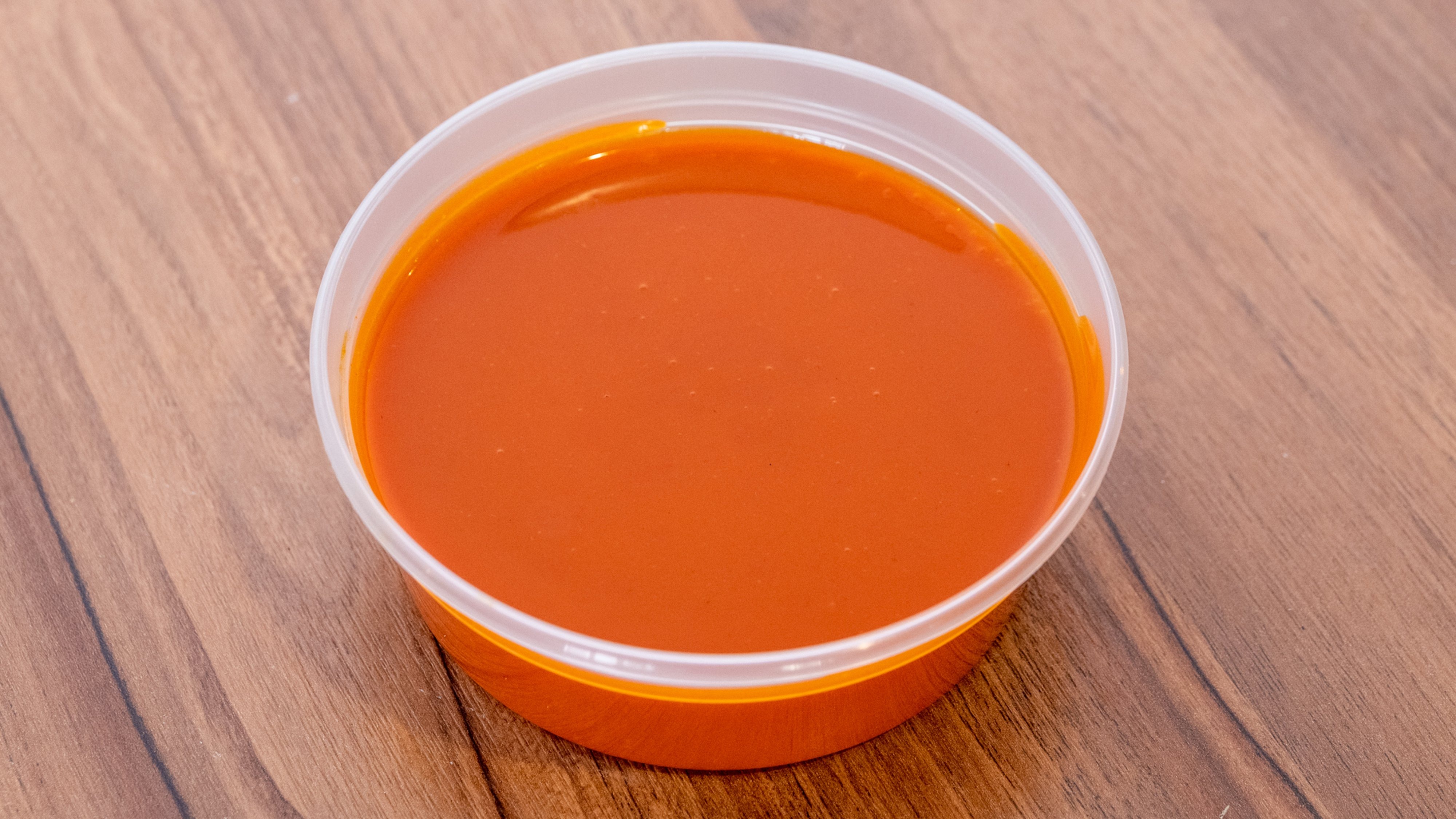 Order Side of Buffalo Sauce - 2 oz food online from Captain Jay's Fish & Chicken store, Southfield on bringmethat.com