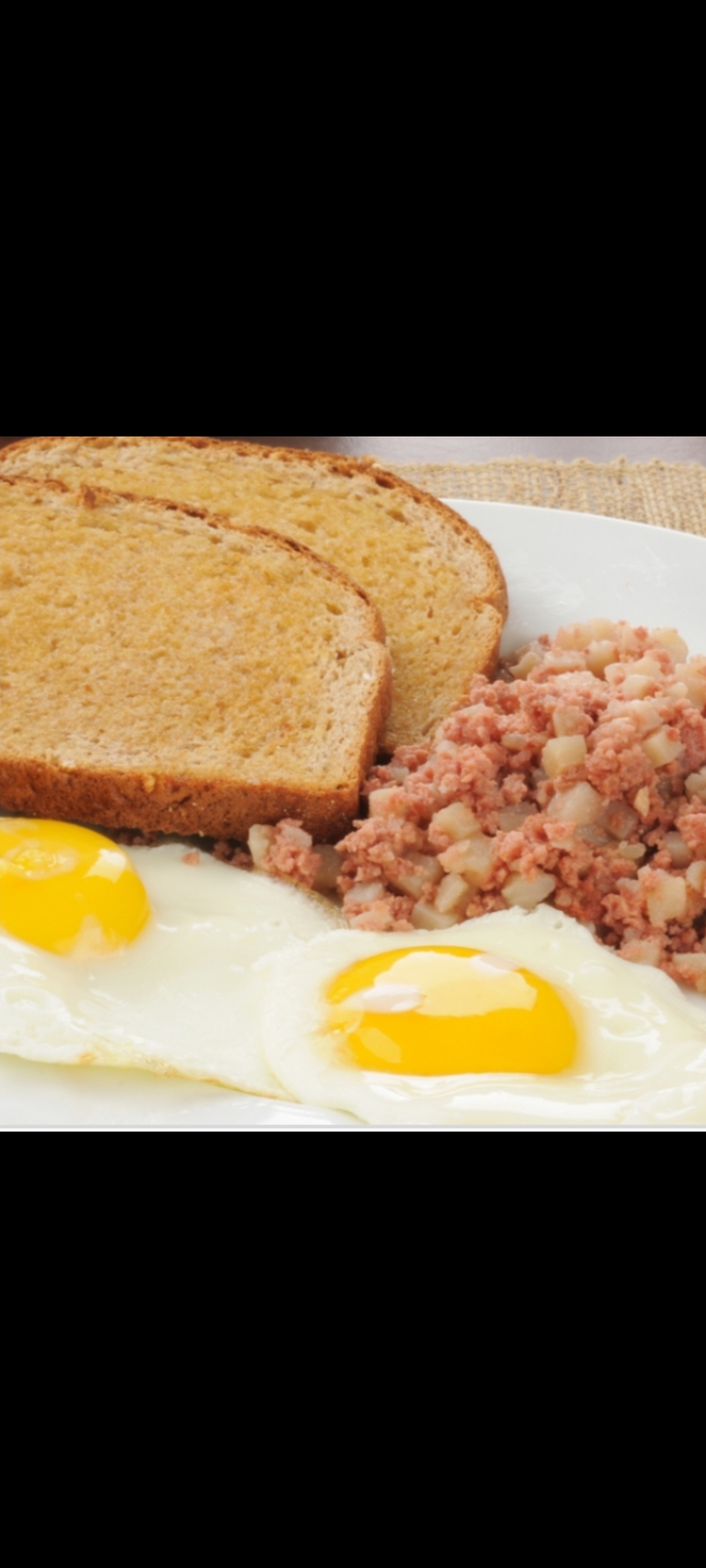Order Eggs Corned Beef Hash  On A Plate & Side Toast  food online from American Gourmet Foods Deli store, New York on bringmethat.com