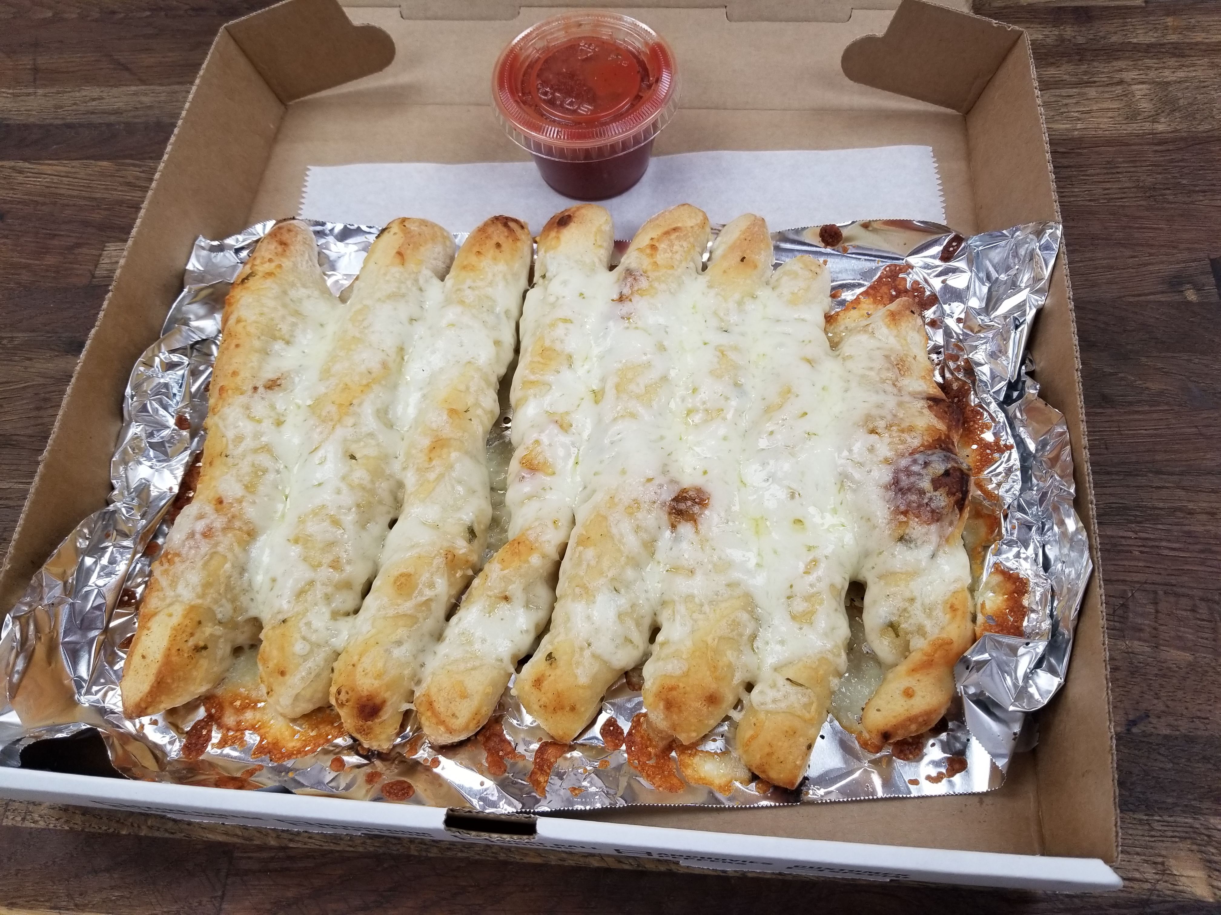 Order Cheesy Breadsticks with Sauce food online from Pizza Italia store, Pittsburgh on bringmethat.com