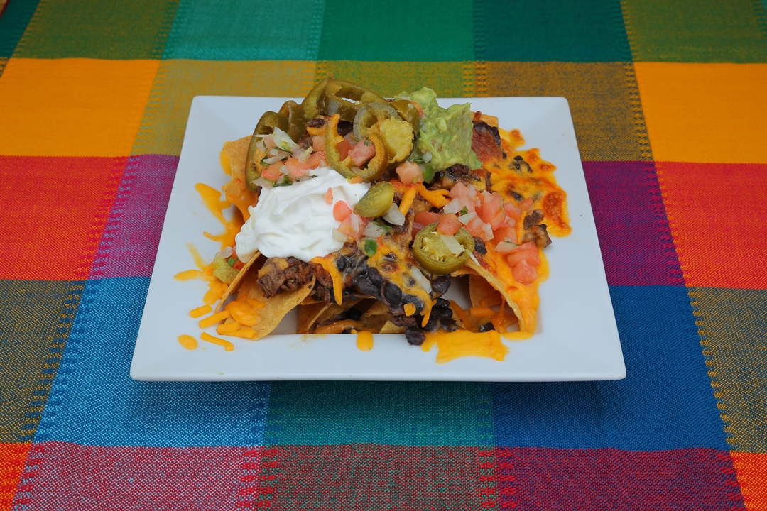 Order Nachos Supreme food online from Refried Beans store, New York on bringmethat.com