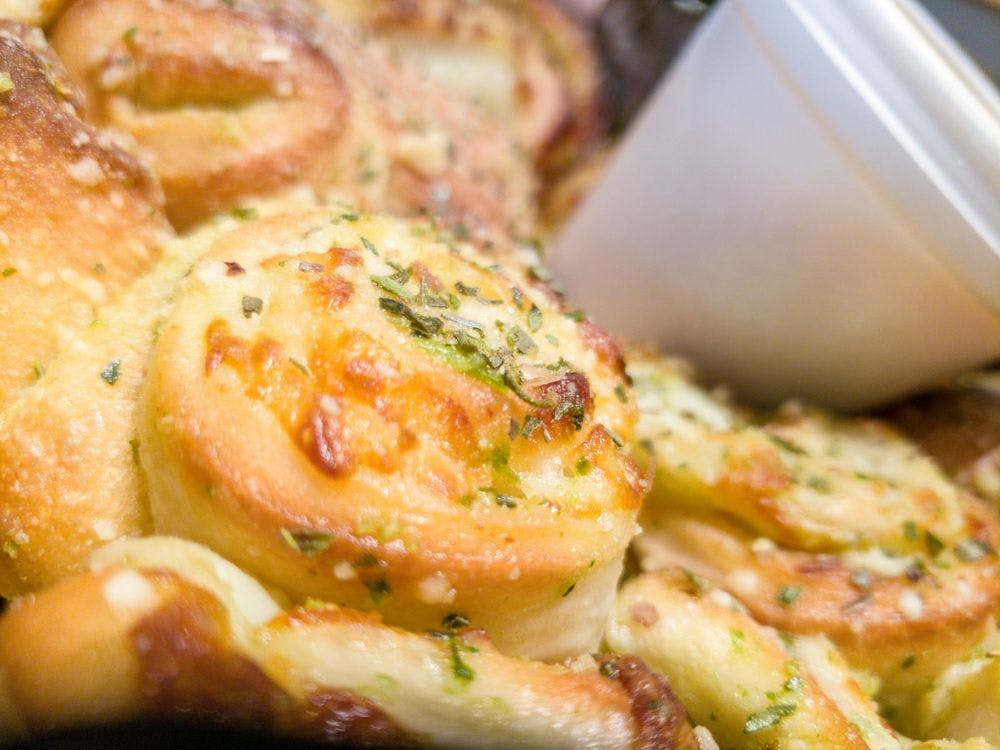 Order Garlic Knots with Cheese - Appetizer food online from Italiano's store, Blacksburg on bringmethat.com