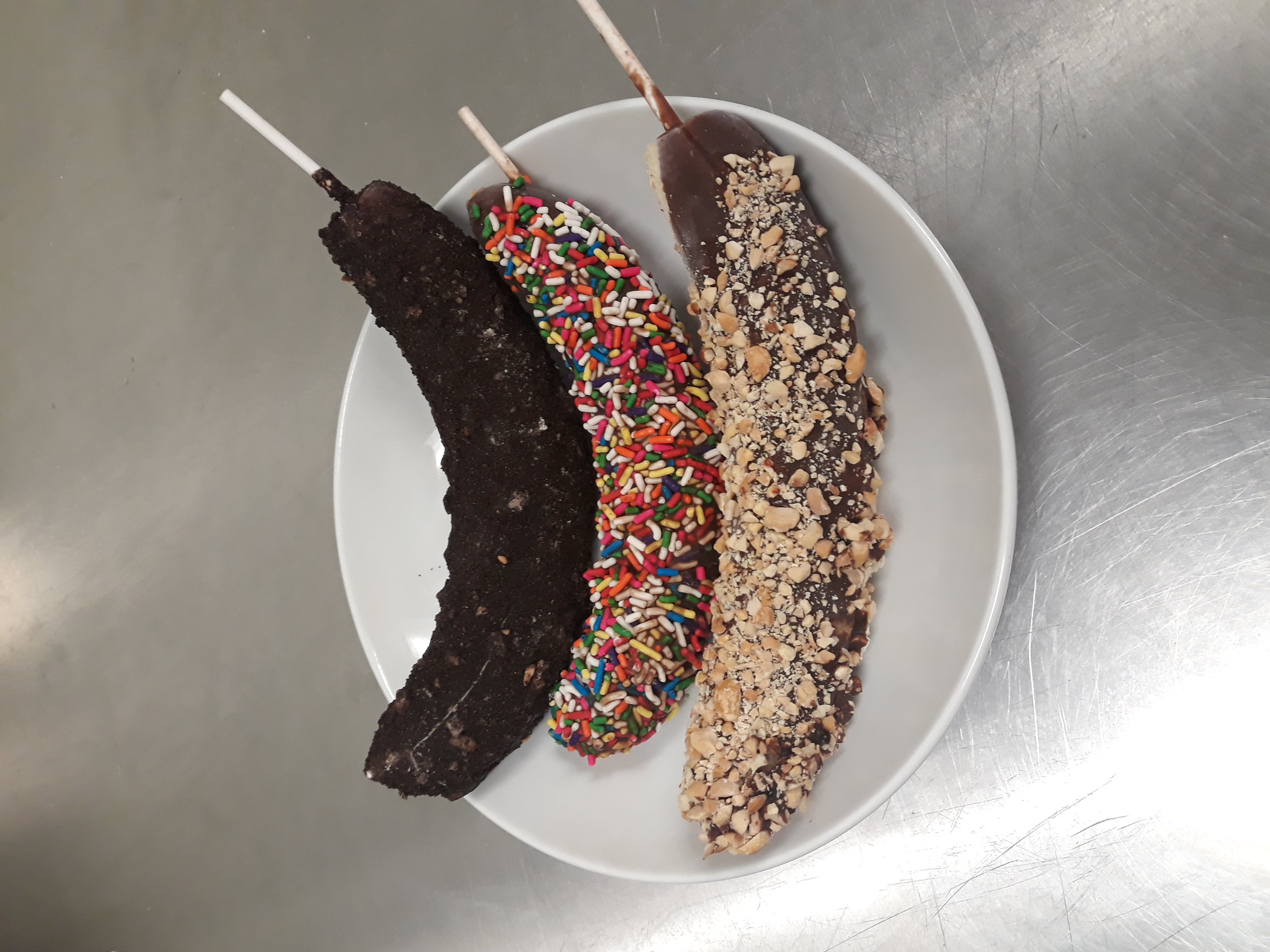 Order Frozen Bananas Dipped in Chocolate food online from The Comfy Cow store, Louisville on bringmethat.com
