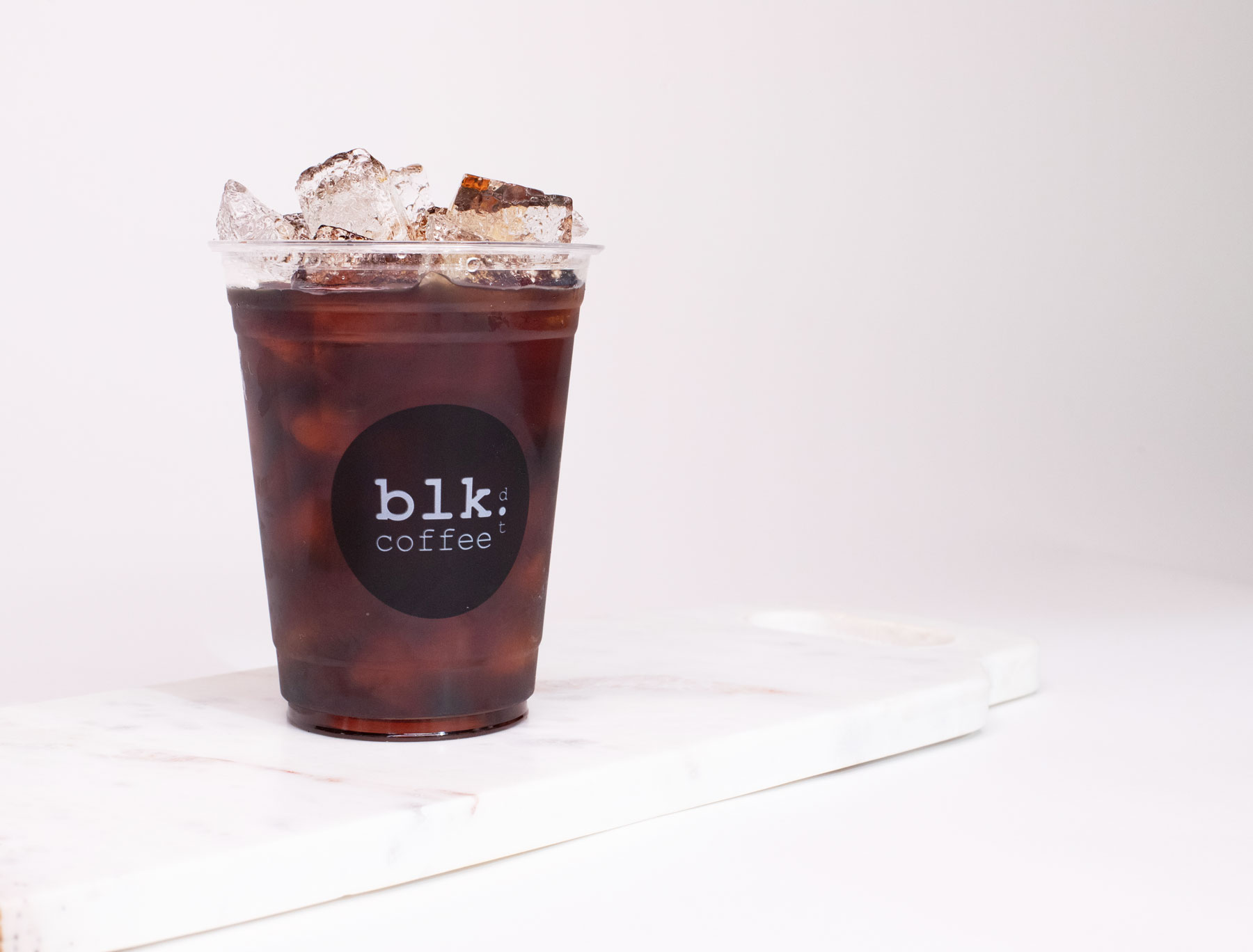 Order Iced Americano Coffee food online from Blk Dot Coffee store, Laguna Beach on bringmethat.com