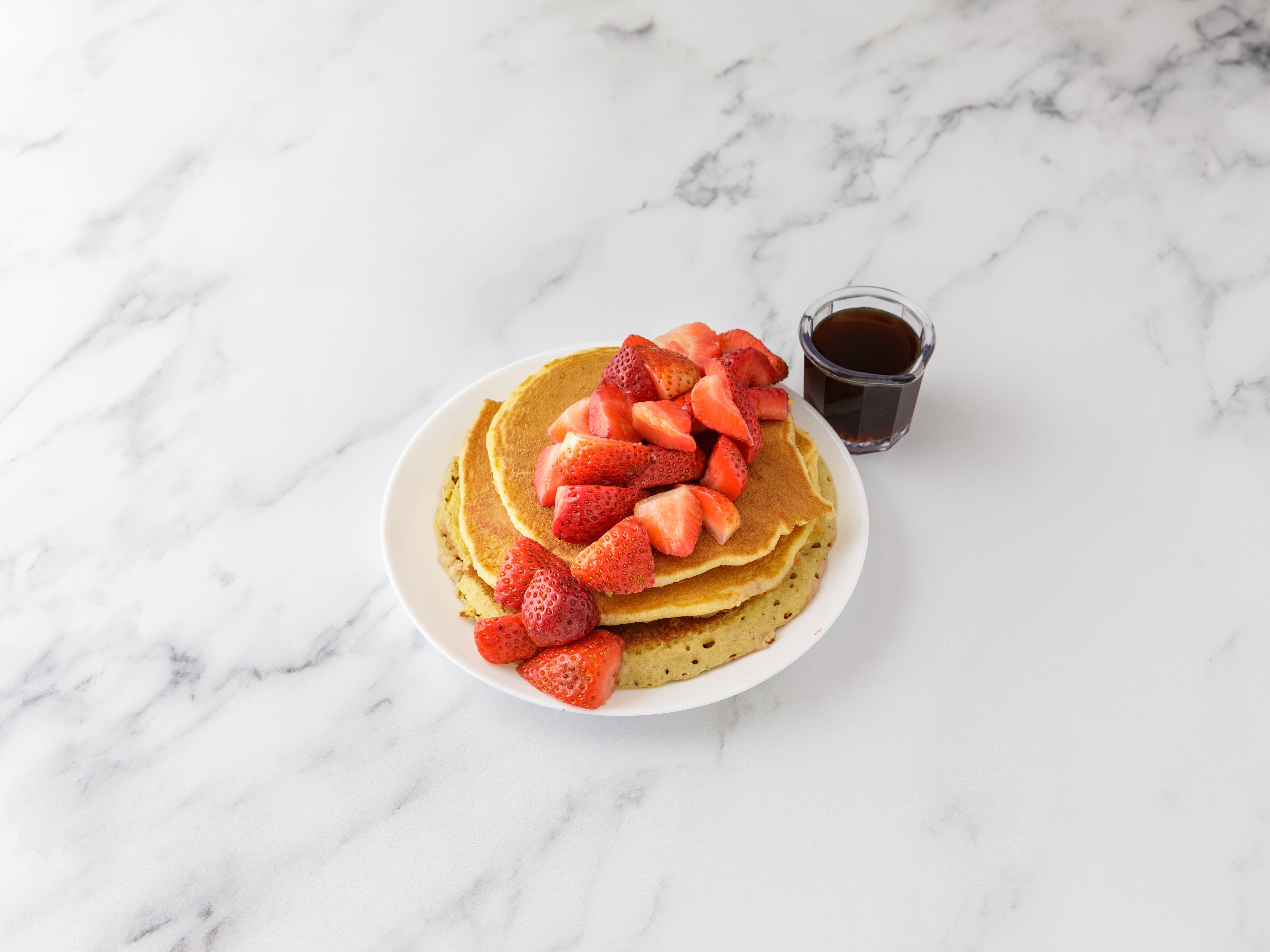 Order 3 Golden Brown Pancakes with Fresh Strawberries food online from All American Pancake House store, New York on bringmethat.com