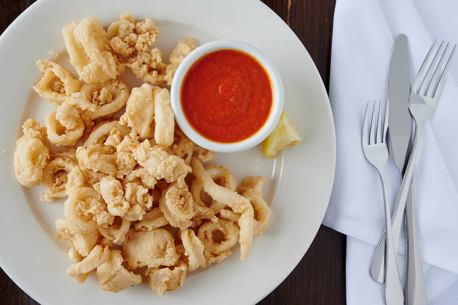 Order Fried Calamari - Appetizer food online from Mario's Restaurant store, Clifton on bringmethat.com