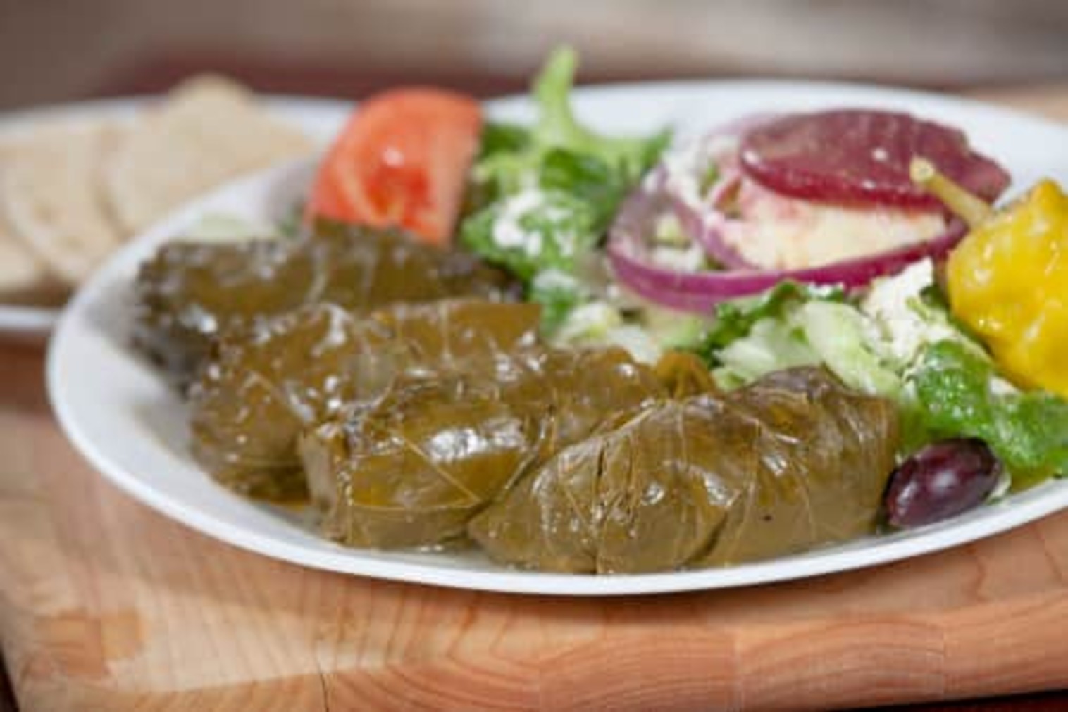 Order Dolmades with Greek Salad food online from Little Greek Fresh Grill store, Youngstown on bringmethat.com
