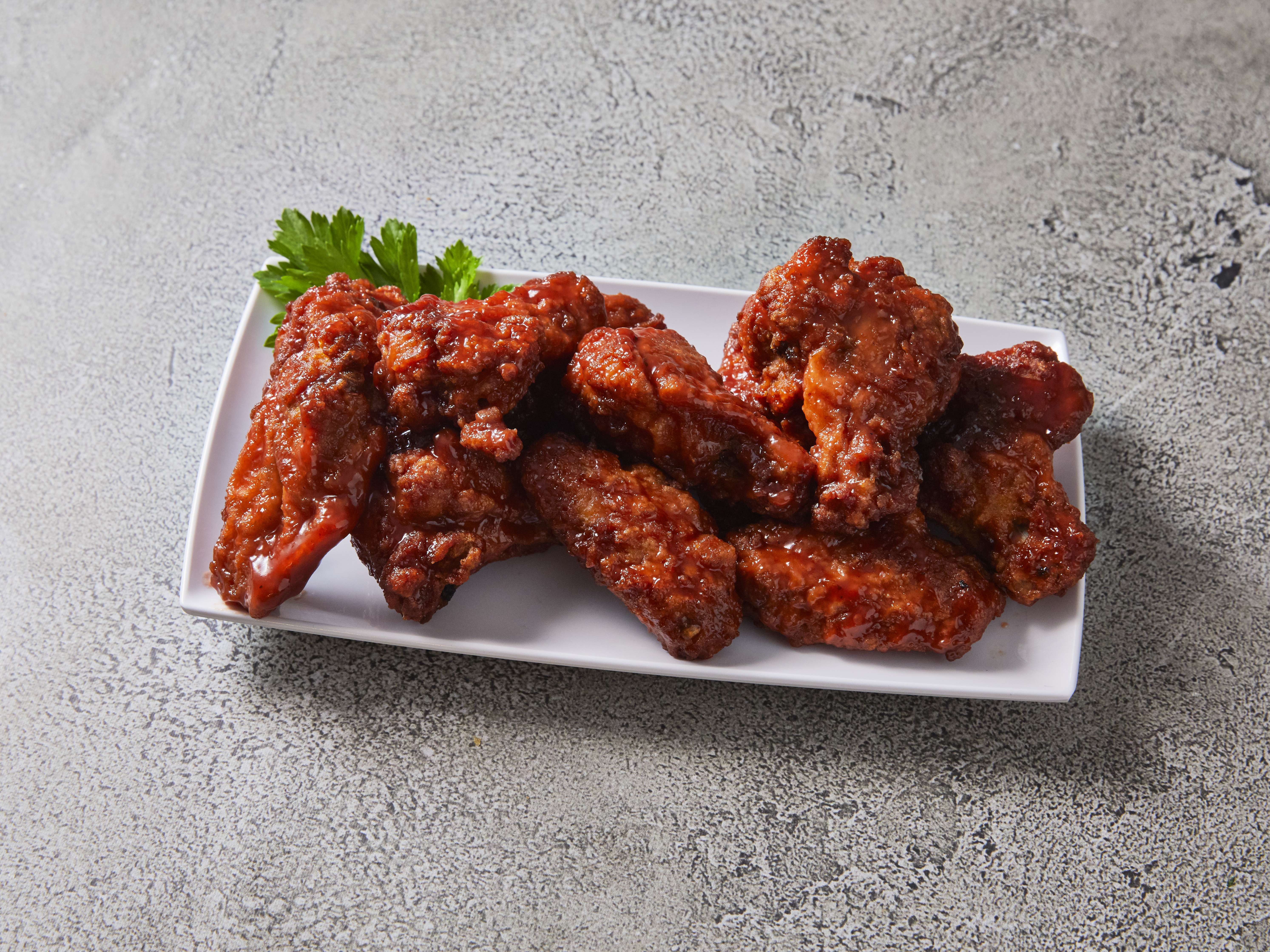 Order 12 Pieces Chicken Wings Starter food online from The Boneyard Bar-B-Que store, Livonia on bringmethat.com
