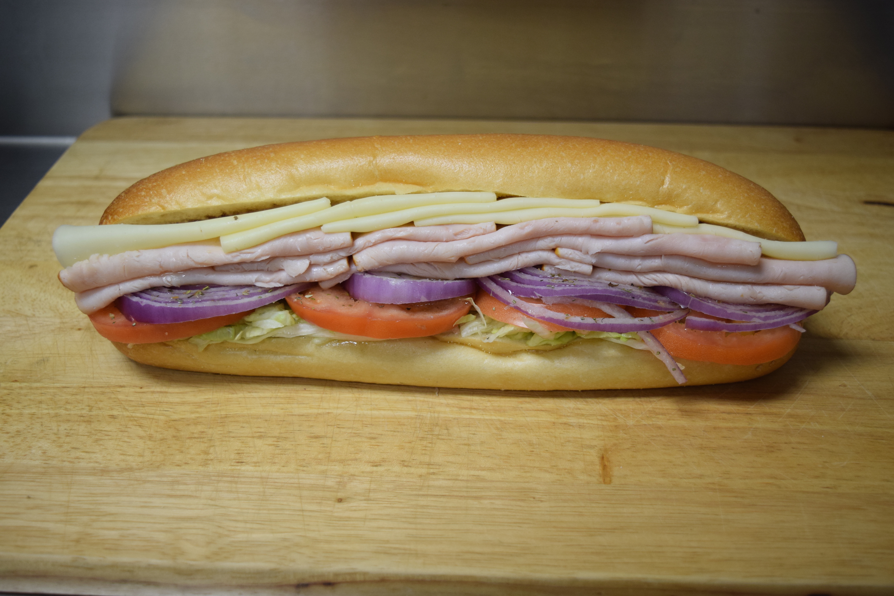 Order Turkey and Cheese Sub food online from Cuzino's store, Bear on bringmethat.com