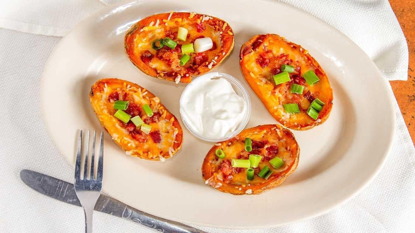 Order Loaded Potato Skins - 4 Pieces food online from Friendly Tavern store, St Marys on bringmethat.com