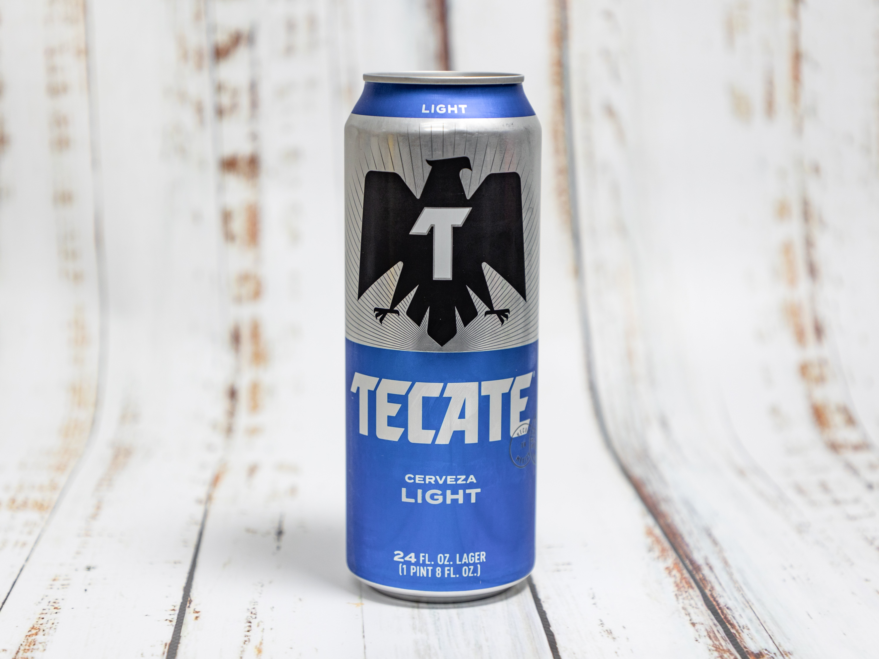 Order Tecate Cerveza Light, 24 oz Can Beer food online from Alessandro Liquor store, Riverside on bringmethat.com