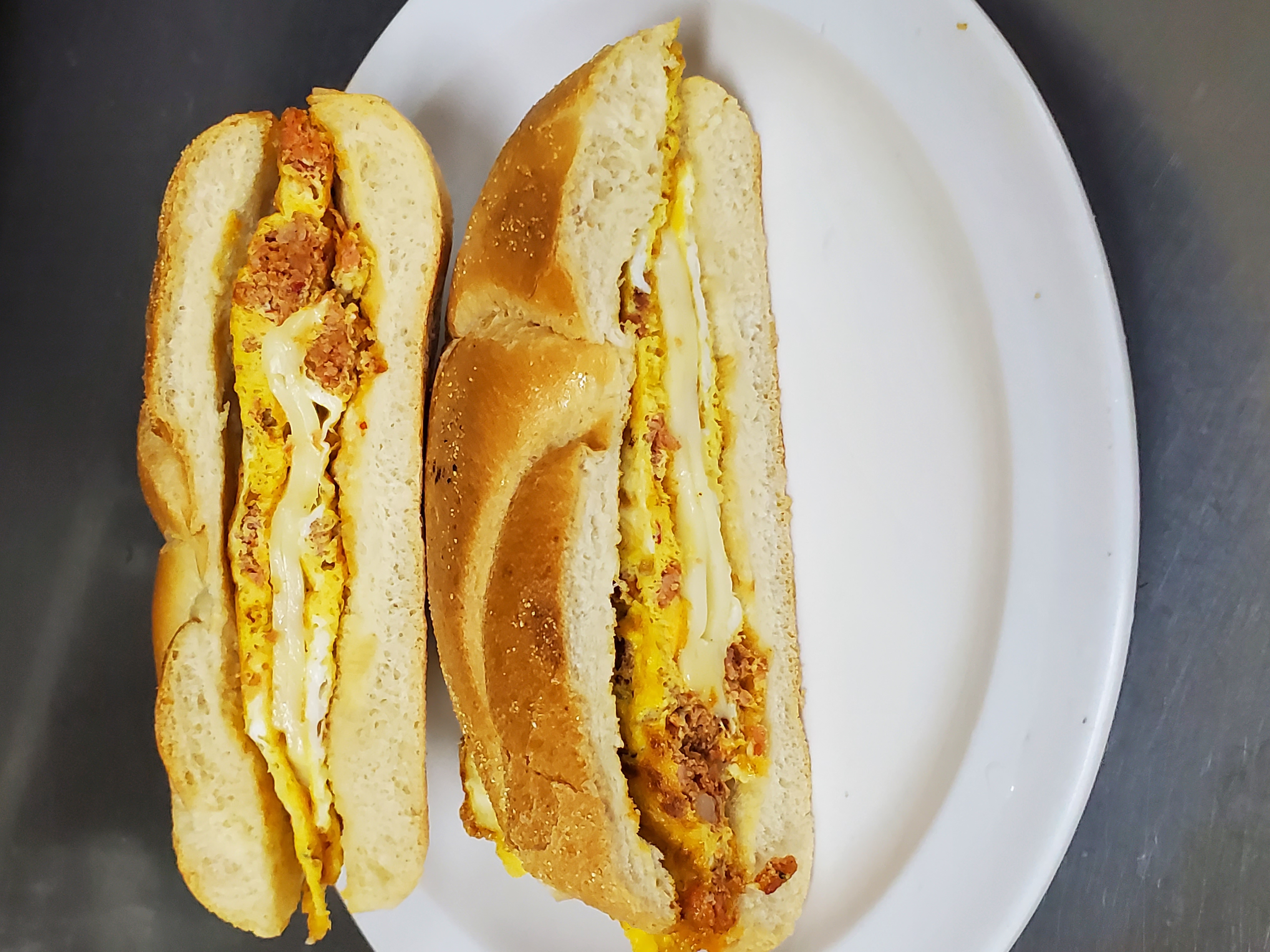 Order Chorizo-egg-cheese sandwiched  food online from Aminas Cafe store, Bronx on bringmethat.com