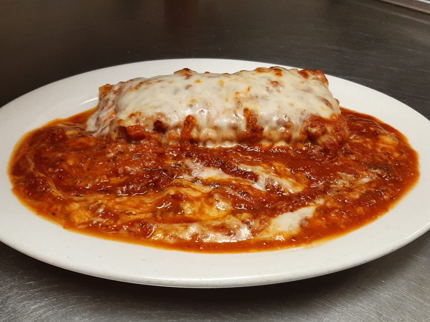 Order Italian Sausage Lasagna - Dinner food online from Reino's Pizza and Pasta store, Tiffin on bringmethat.com