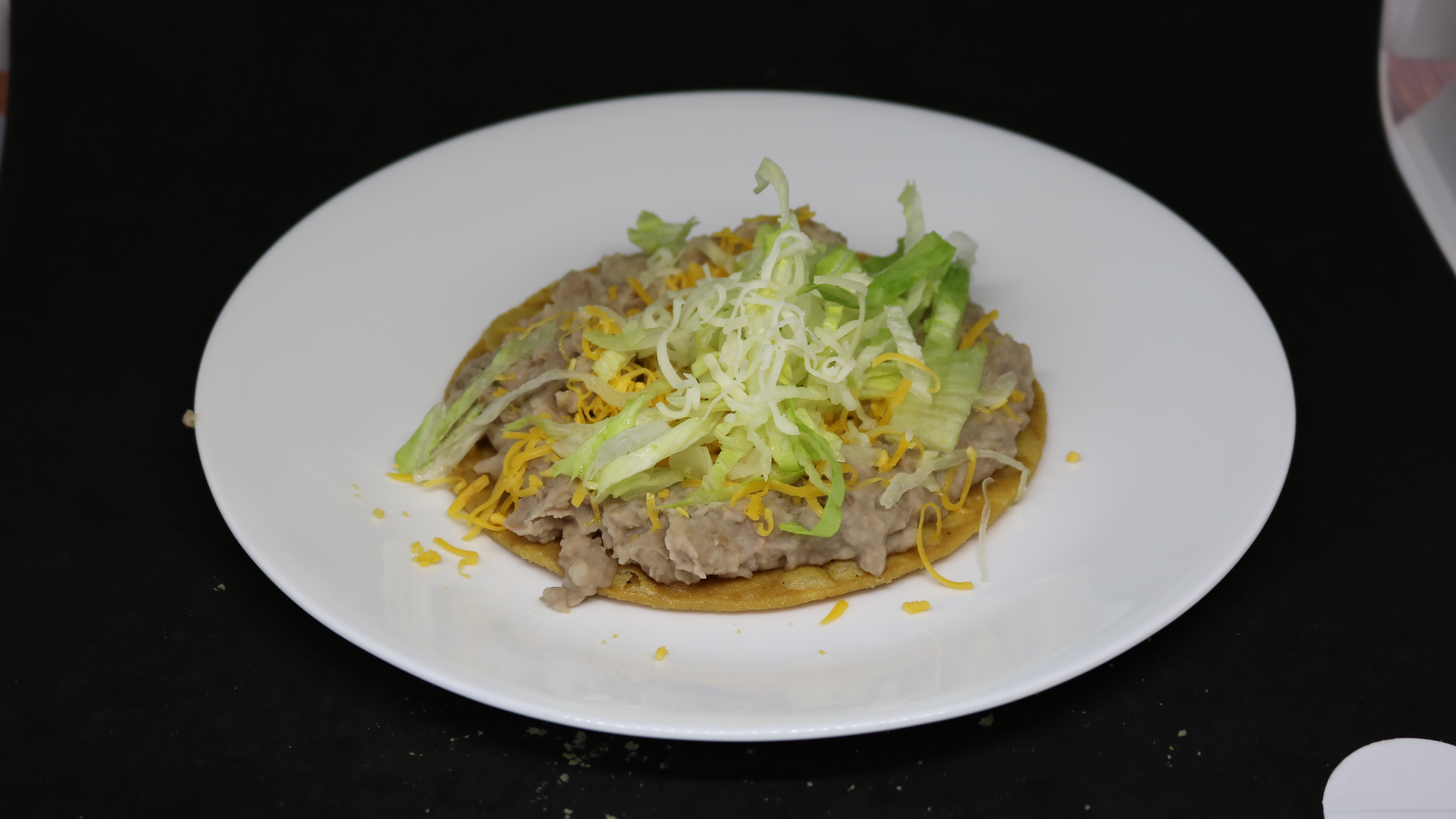 Order Beans Tostada food online from Albertaco's Mexican Food Inc store, Cypress on bringmethat.com