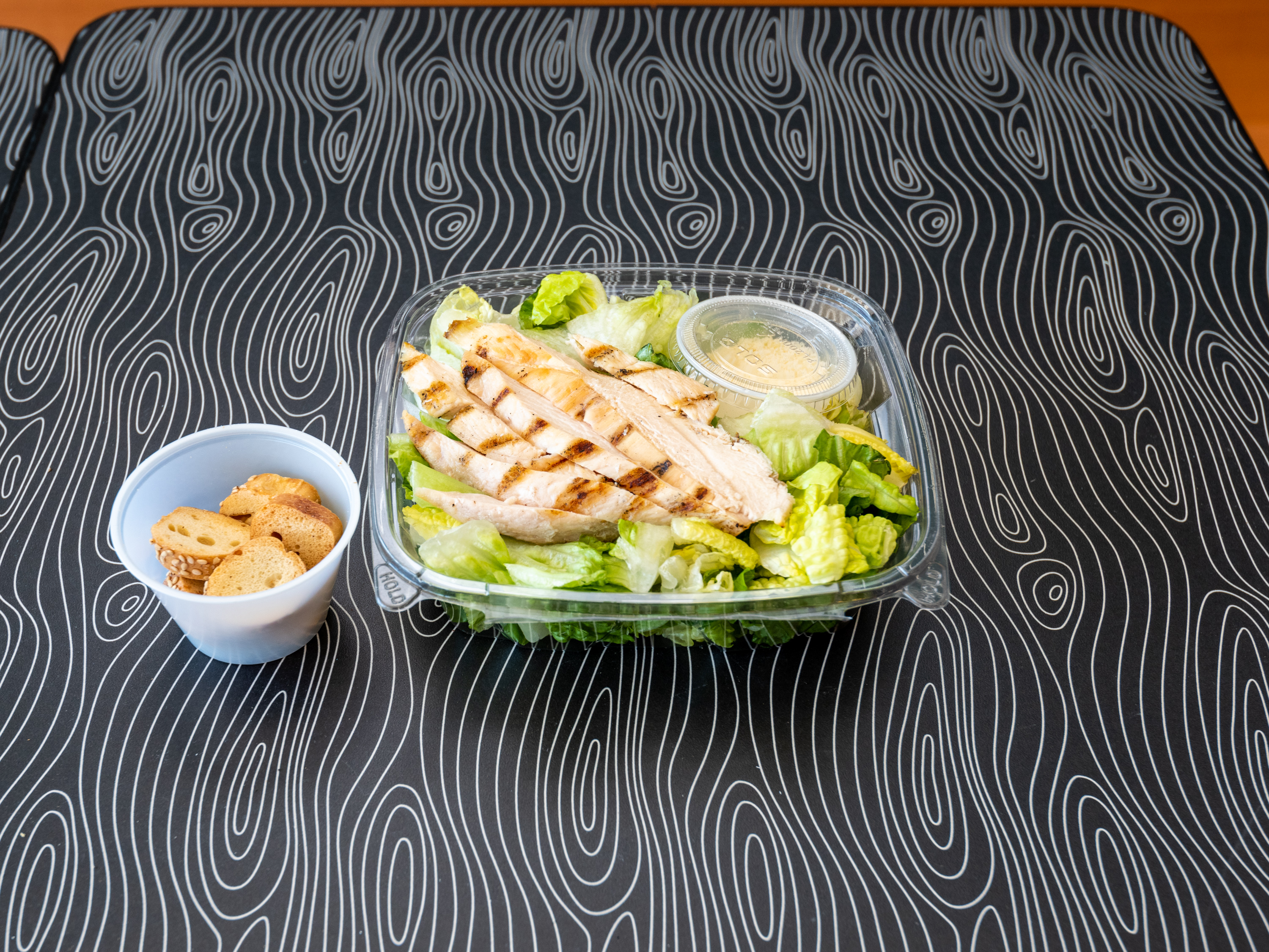Order Grilled Chicken Caesar Salad food online from Between Rounds Bakery Sandwich Cafe store, Manchester on bringmethat.com