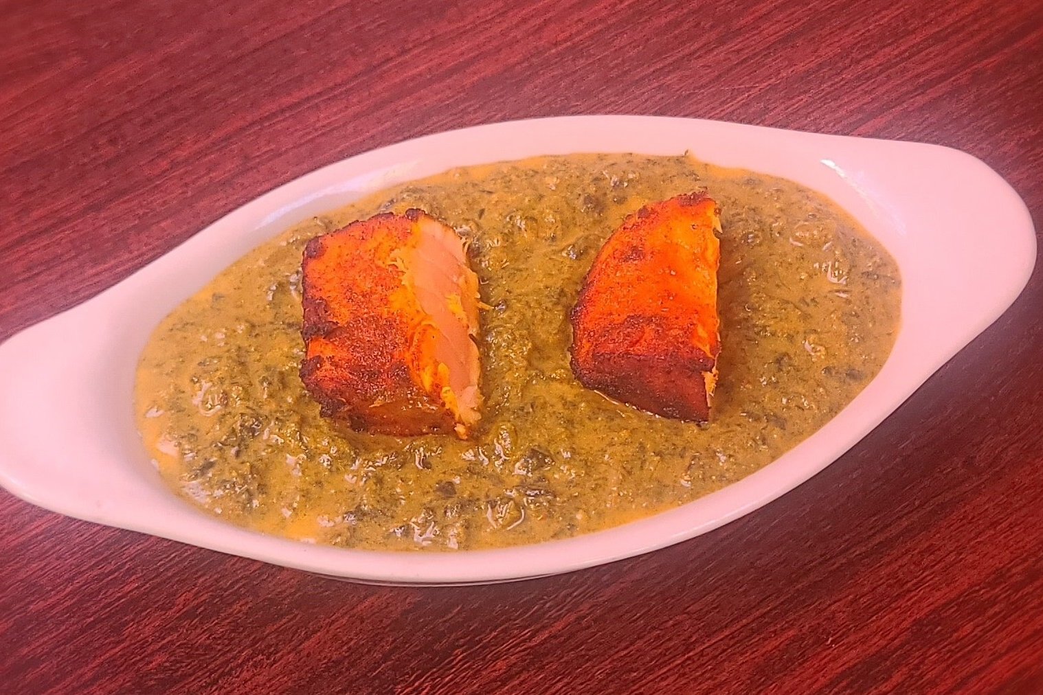 Order Salmon Saag Curry food online from Royal Indian Cuisine store, San Francisco on bringmethat.com