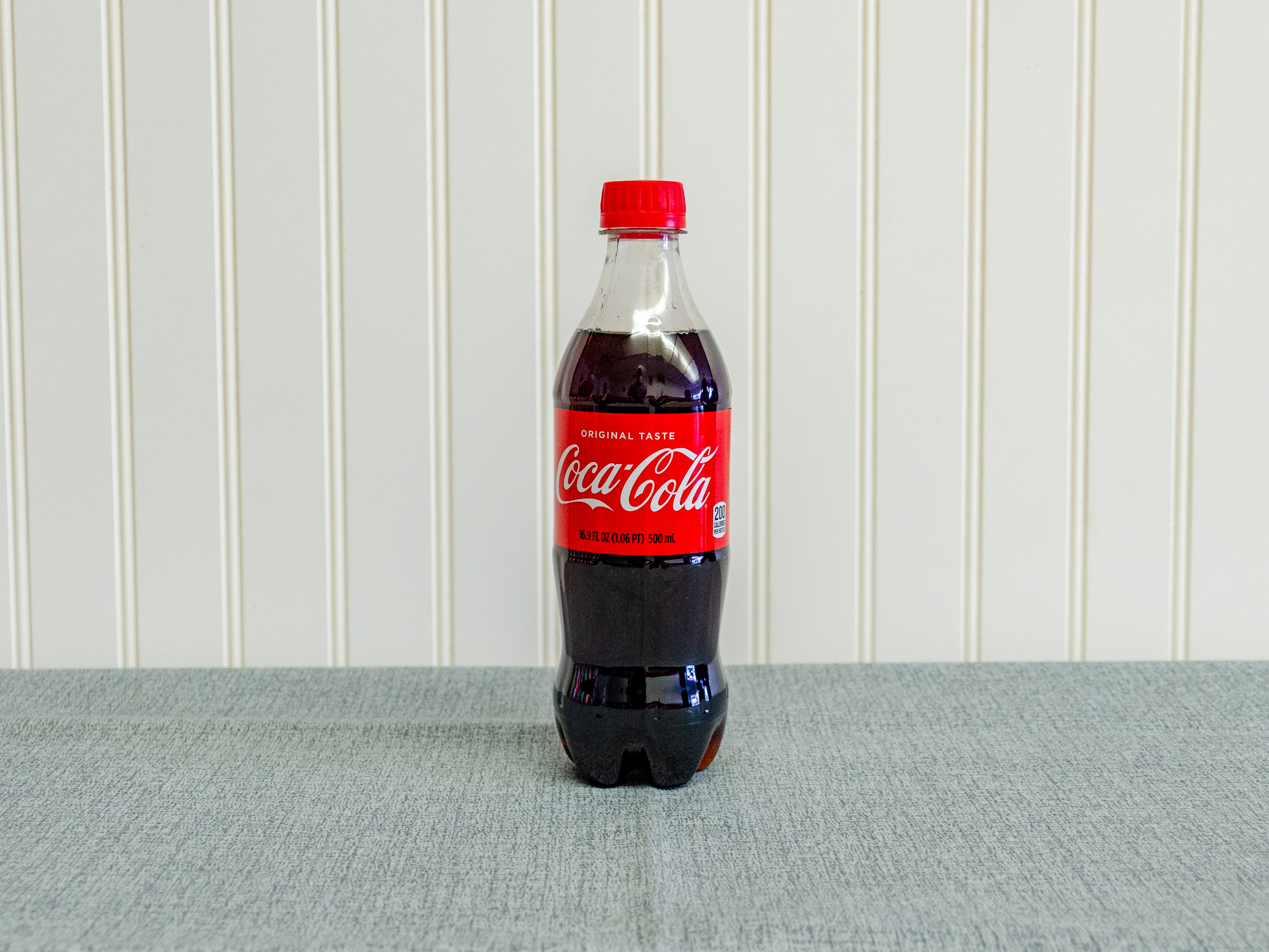 Order 16.9 oz. Coke food online from Just Dash It store, Englewood on bringmethat.com