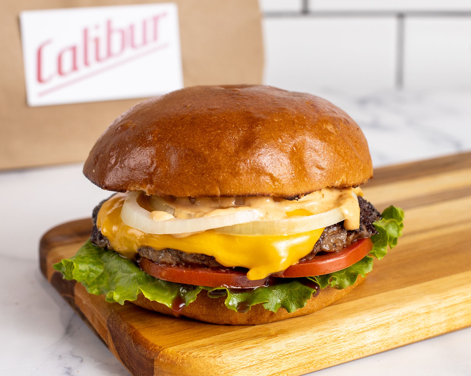 Order Single Cheeseburger food online from Calibur Express store, San Francisco on bringmethat.com