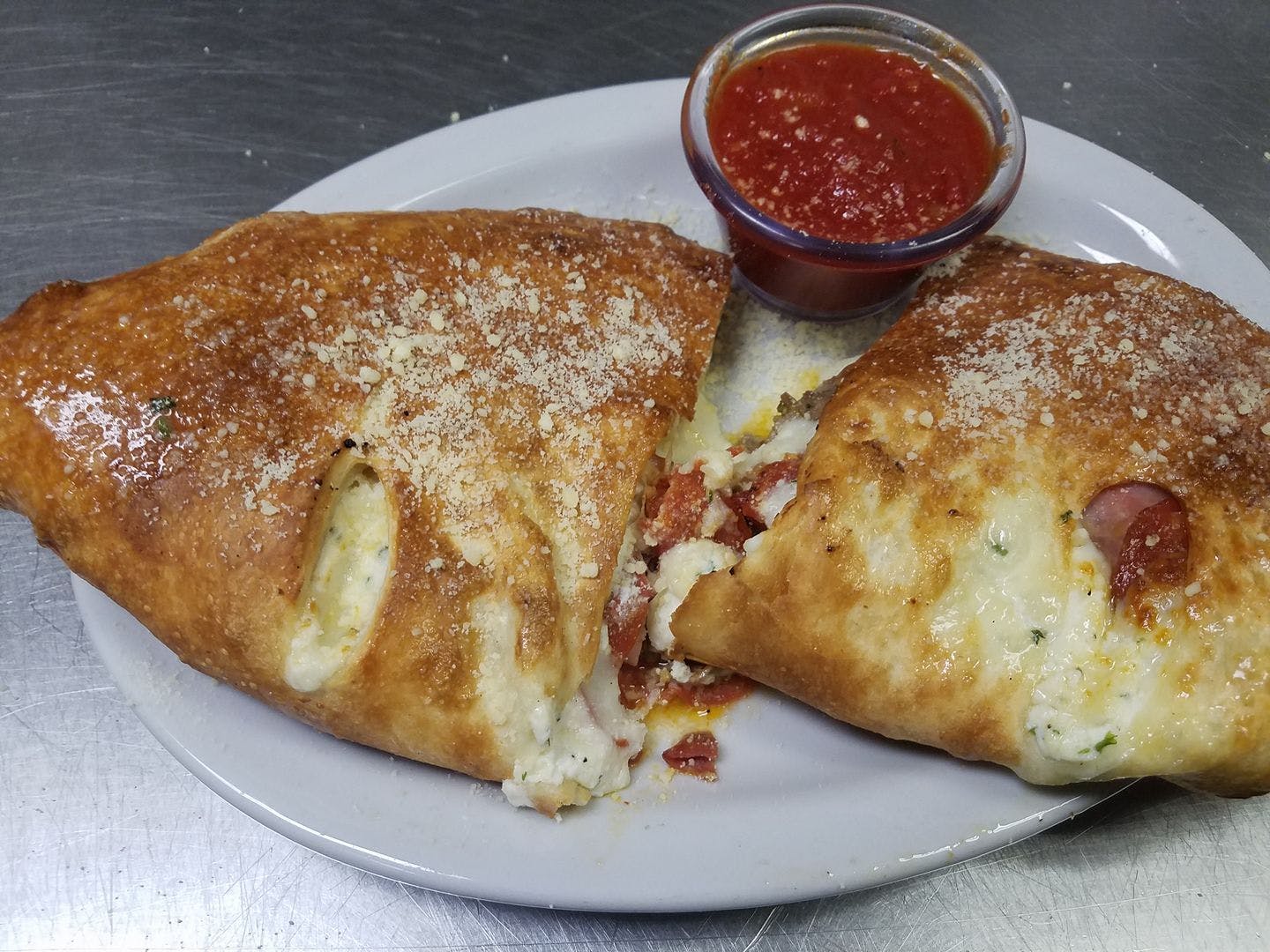 Order Meat Calzone - Calzone food online from Bella Pizza & Pasta store, Mesa on bringmethat.com